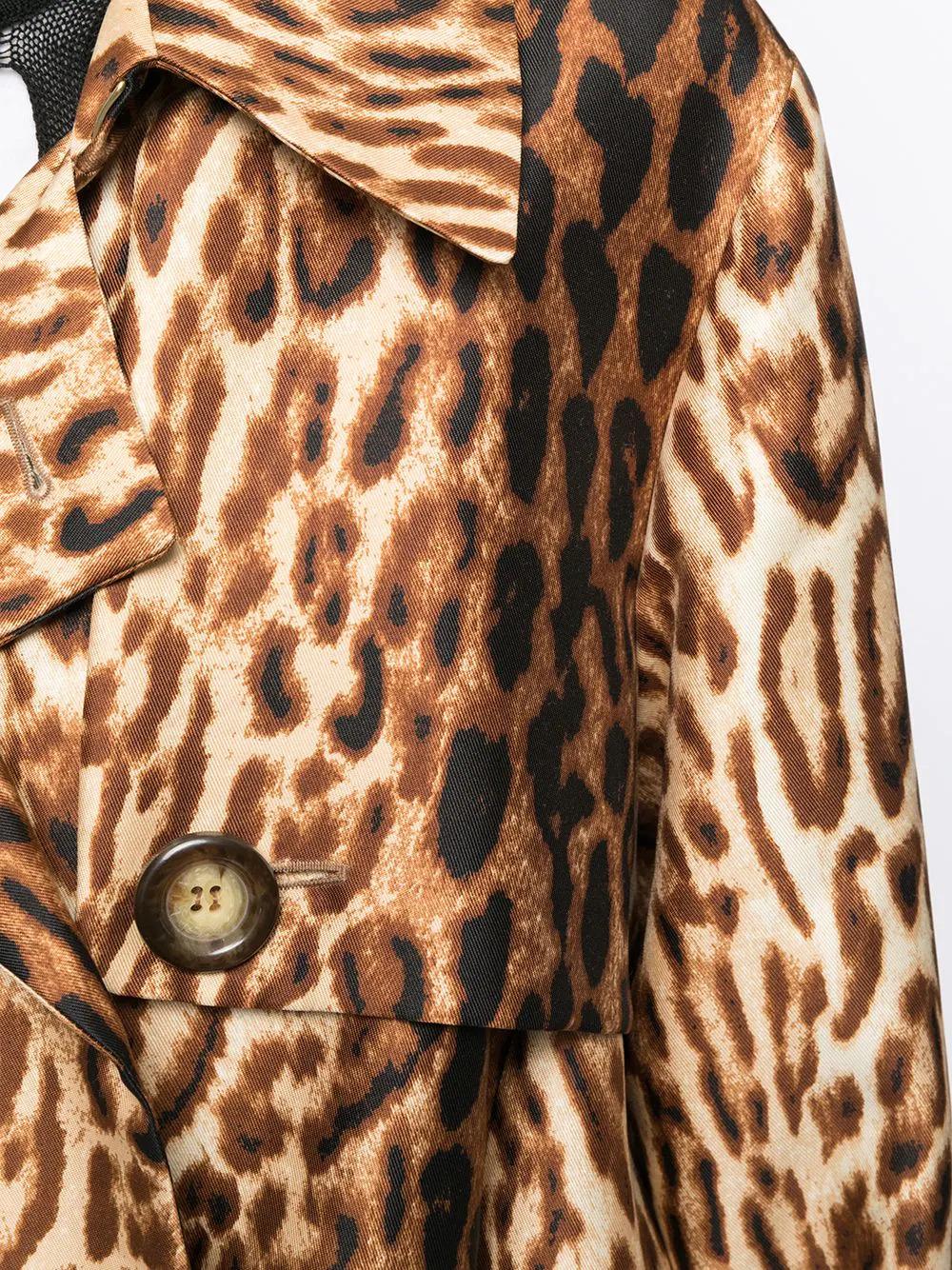 Crafted in France from a soft wool and silk blend, this pre-owned, midi-length trench coat from Celine, features a slick flared style shape, full length sleeves and a double-breasted design, with a bold leopard print pattern, for a touch of chic yet