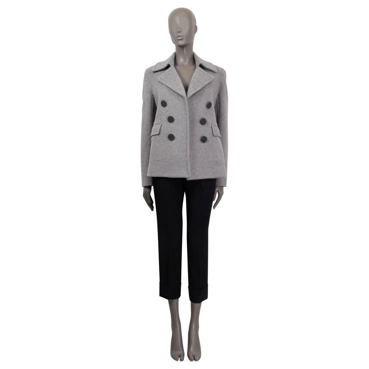 100% authentic Celine open front peacoat jacket in light gray cashmere (100%). Features two sewn shut flap pockets, slits on both sides and a notch collar. Partially lined in light gray silk (100%). Has been worn and is in excellent
