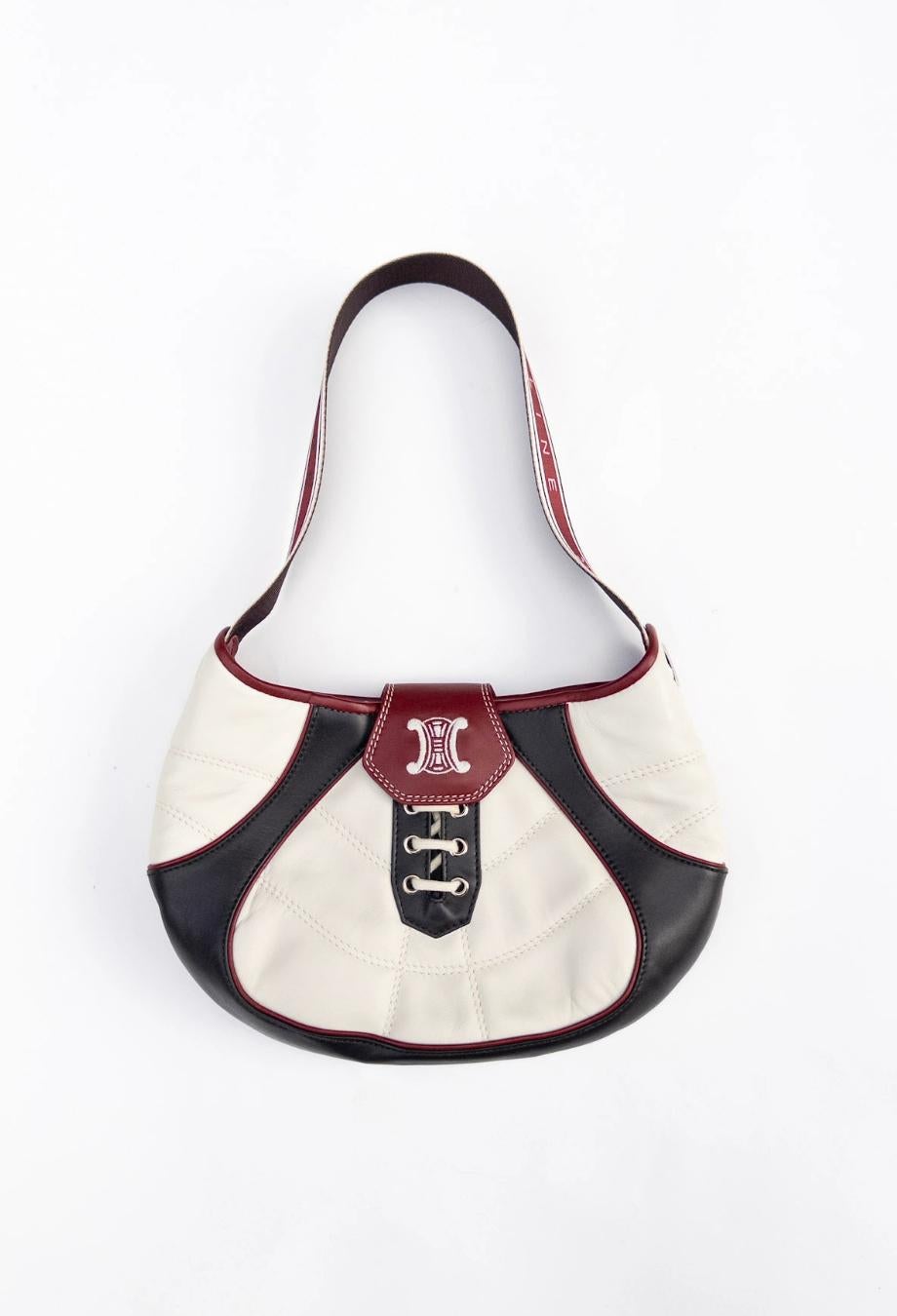Released to commemorate the 2002 FIFA World Cup, Celine’s limited-edition football bag captures a rare fusion of sport and high fashion from the maison’s early 2000s era. Crafted in smooth tri-colour leather—ivory, oxblood, and black—the silhouette
