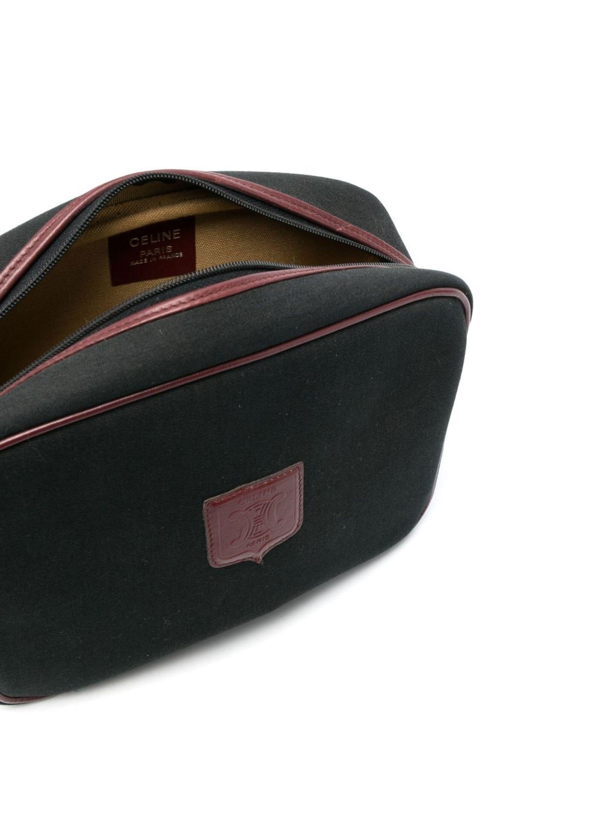 Celine logo patch camera bag featuring a camera rectangle body, black cotton base & burgundy leather front logo patch and the adjustable shoulder strap,  a top zip fastening, internal logo patch, tarnish gold-tone hardware.  
Circa 1980s. Made in