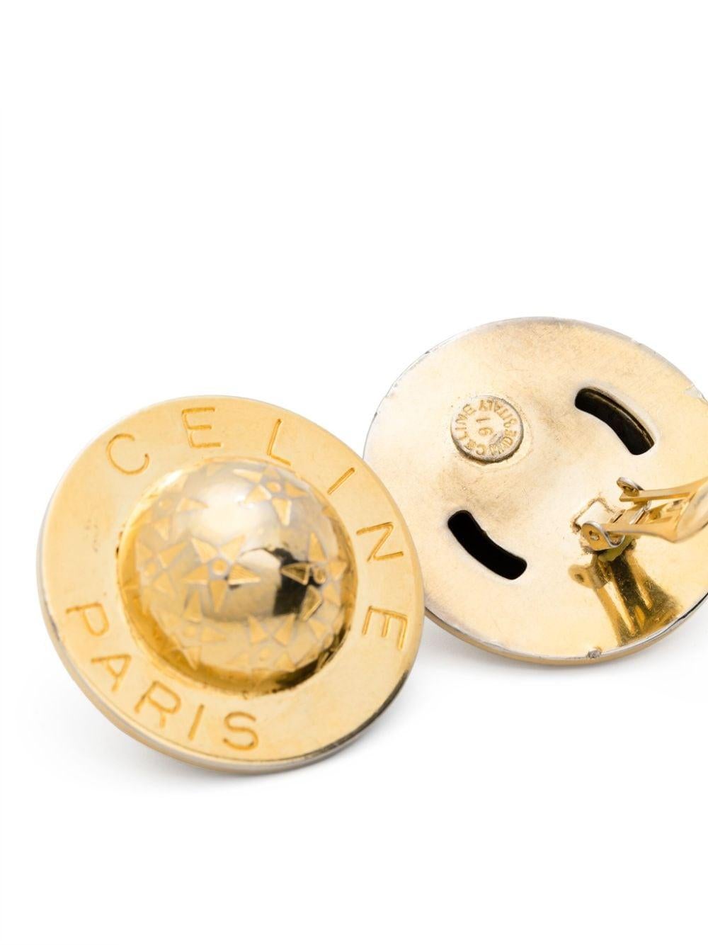 Celine 1980s logo-engraved circular clip-on earrings featuring gold-tone polished finish, clip-on design, engraved logo, engraved detail.
These earrings come as a pair. 
Circa: 1990s Made in France
1.18in. (3cm) X 1.18in. (3cm) 
In Good  vintage