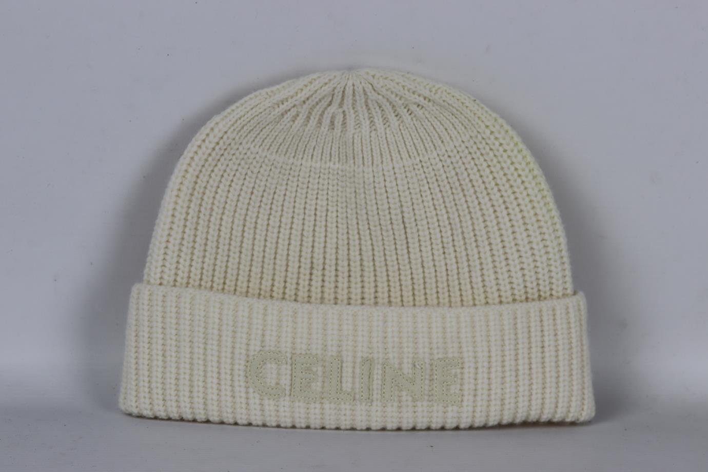 Celine logo detailed ribbed wool beanie. White. Slips on. 100% Wool. Does not come with dustbag or box. Size: One Size. Circumference: 18.4 in. Good condition - Some discolouration at side; see pictures.
