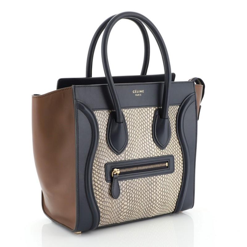 This Celine Luggage Handbag Python and Leather Micro, crafted in brown and blue genuine python and leather, features dual rolled handles, front zip pocket, and aged gold-tone hardware. Its zip closure opens to a blue leather interior with zip and