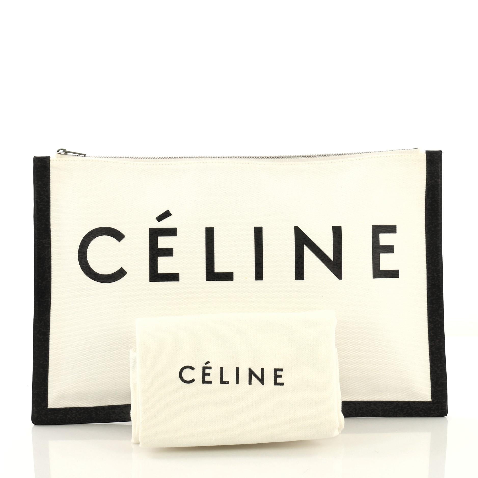 This Celine Made In Pouch Printed Canvas Large, crafted in printed white canvas and black leather, features Celine Paris logo print and silver-tone hardware. Its zip closure opens to a white canvas interior with card slots. 

Estimated Retail Price: