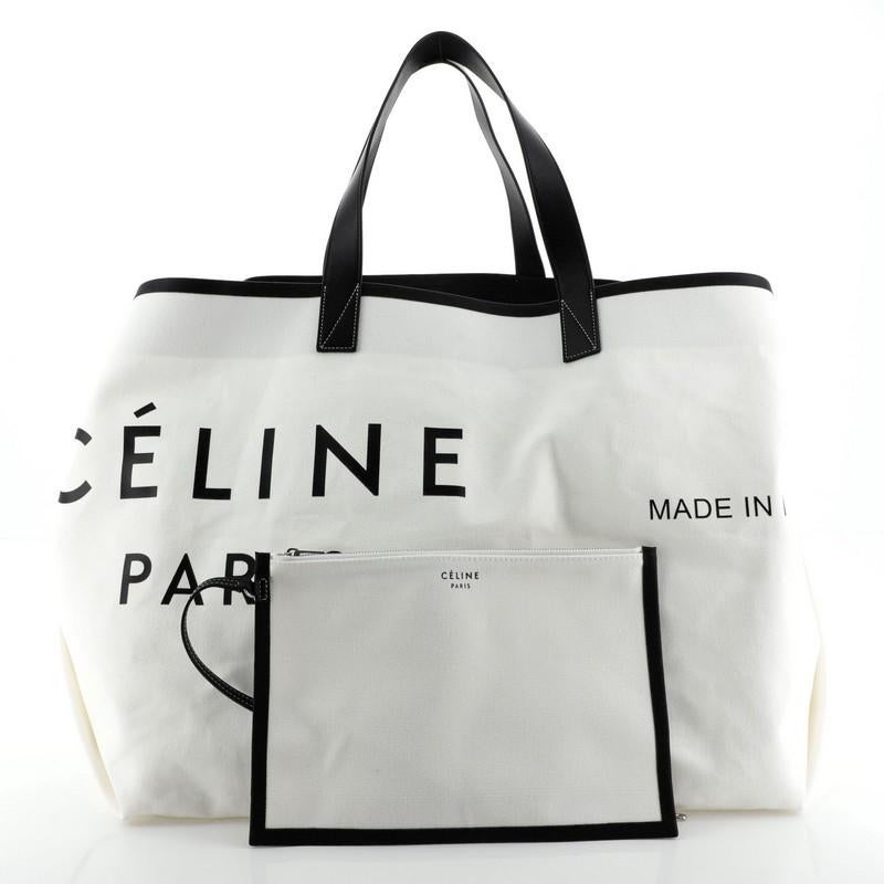 This Celine Made In Tote Canvas with Leather Large, crafted in white canvas, features dual leather handles and silver-tone hardware. It opens to a white canvas interior. 

Condition: Excellent. Light wear on exterior and in interior opening,