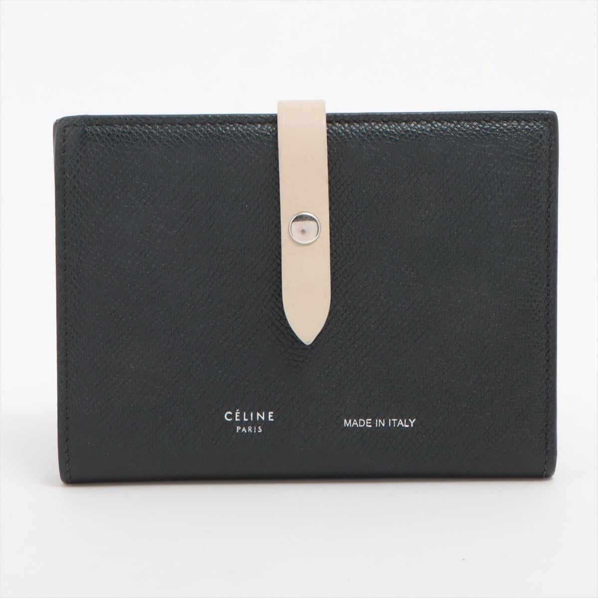 The Celine Medium Bifold Leather Compact Wallet in Black and Cream is a refined and functional accessory, perfect for those who appreciate minimalist elegance. Crafted from premium leather, the wallet features a sleek black exterior paired with a