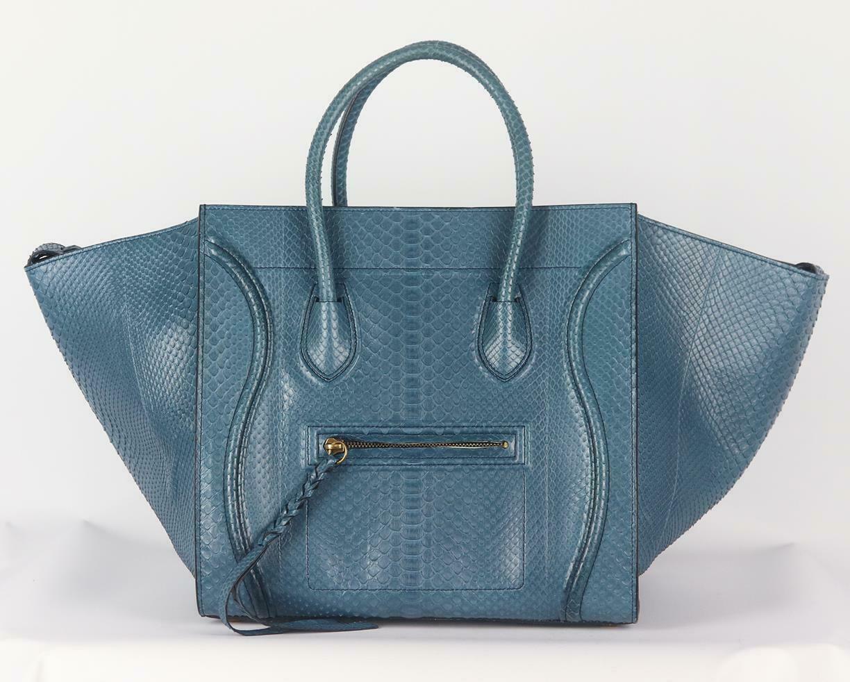 This flawlessly crafted python and leather phantom luggage tote bag is has been part of Celine's timeless collection, it's designed with multiple internal pockets and an oversized external flaps which can be pulled in to ensure your belongings are
