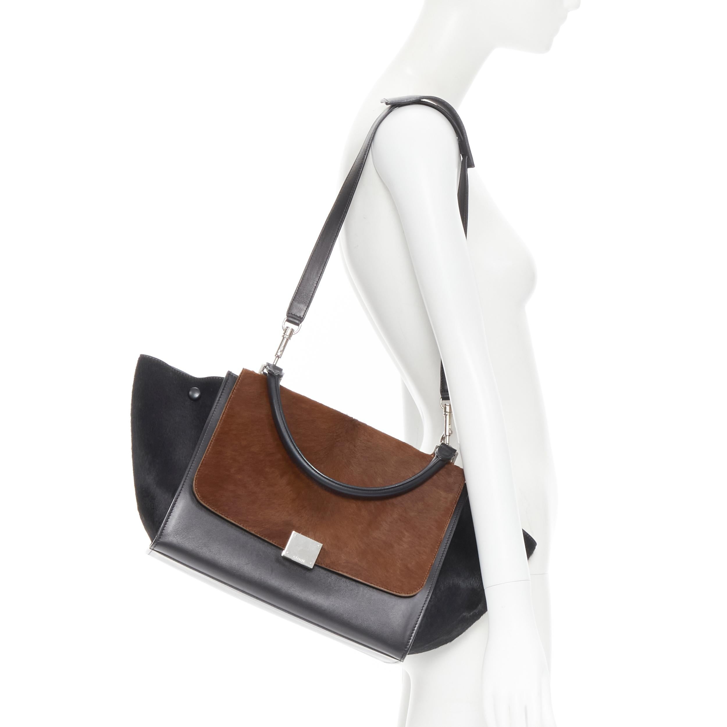 CELINE Medium Trapeze black brown horse hair silver buckle crossbody satchel bag 
Reference: GIYG/A00088 
Brand: Celine 
Designer: Phoebe Philo 
Model: Medium Trapeze 
Material: Leather 
Color: Brown 
Pattern: Solid 
Closure: Clasp 
Extra Detail: