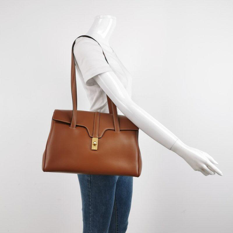 Celine Medoim Soft 16 Bag Caramel Natural Tan Smooth Calfskin Leather
 These are professional photos of the actual bag.
 This Celine 16 Bag is elegantly designed, showcasing a unique blend of classic and modern elements. Dressed in a stunning