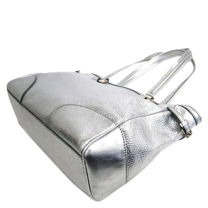 Founded in 1945, Celine has been known for luxury and stylish goods. This bag is another elegant addition to their lineup. Made of stunning metallic silver calfskin, this bag has a brand detail on the front. The bag has a top opening secured by a