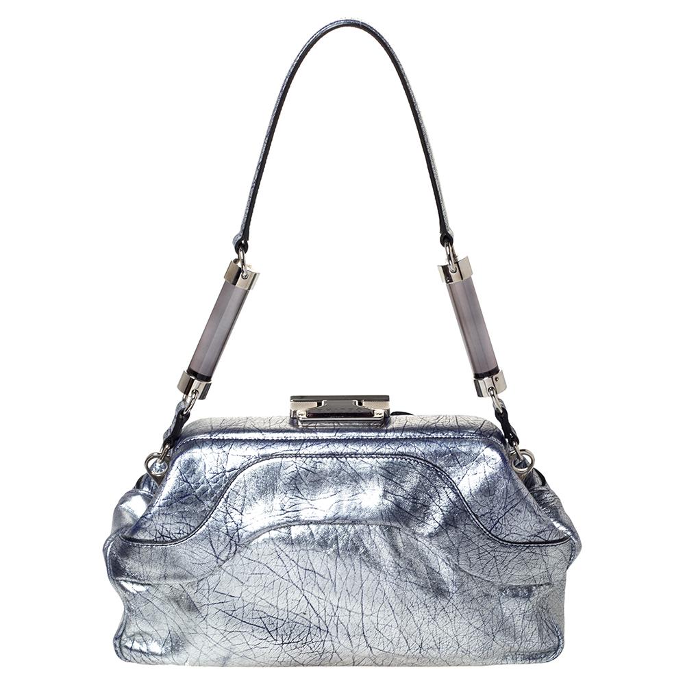 This cute and feminine bag from Celine will be your favorite arm candy. Made from soft crackled leather, this luxe bag features a top handles, a lock on the top and silver-tone hardware. The exterior comes with four outer slip pockets whereas, the