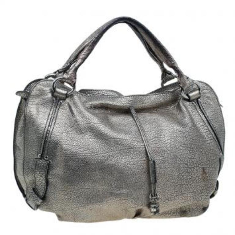 This spacious Celine ‘Bittersweet’ hobo is stylish and practical. It is crafted from silver metallic leather and is equipped with leather trim, handles, a top zip closure and a hidden drawstring with a charm at the front. The spacious bag opens up