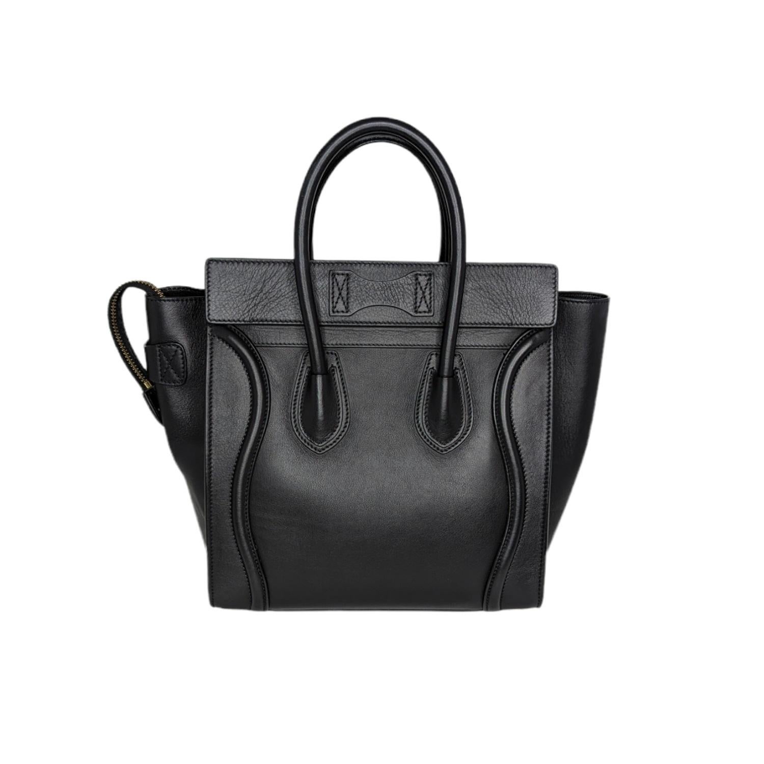 Micro Luggage Handbag in smooth Calfskin with leather handles, a single zip closure, and a zipped outer pocket on the front. Retail price is $3,150.

Brand: Celine
Material: Calfskin leather
Color: Black
Origin: Italy
Date/Authenticity Code: