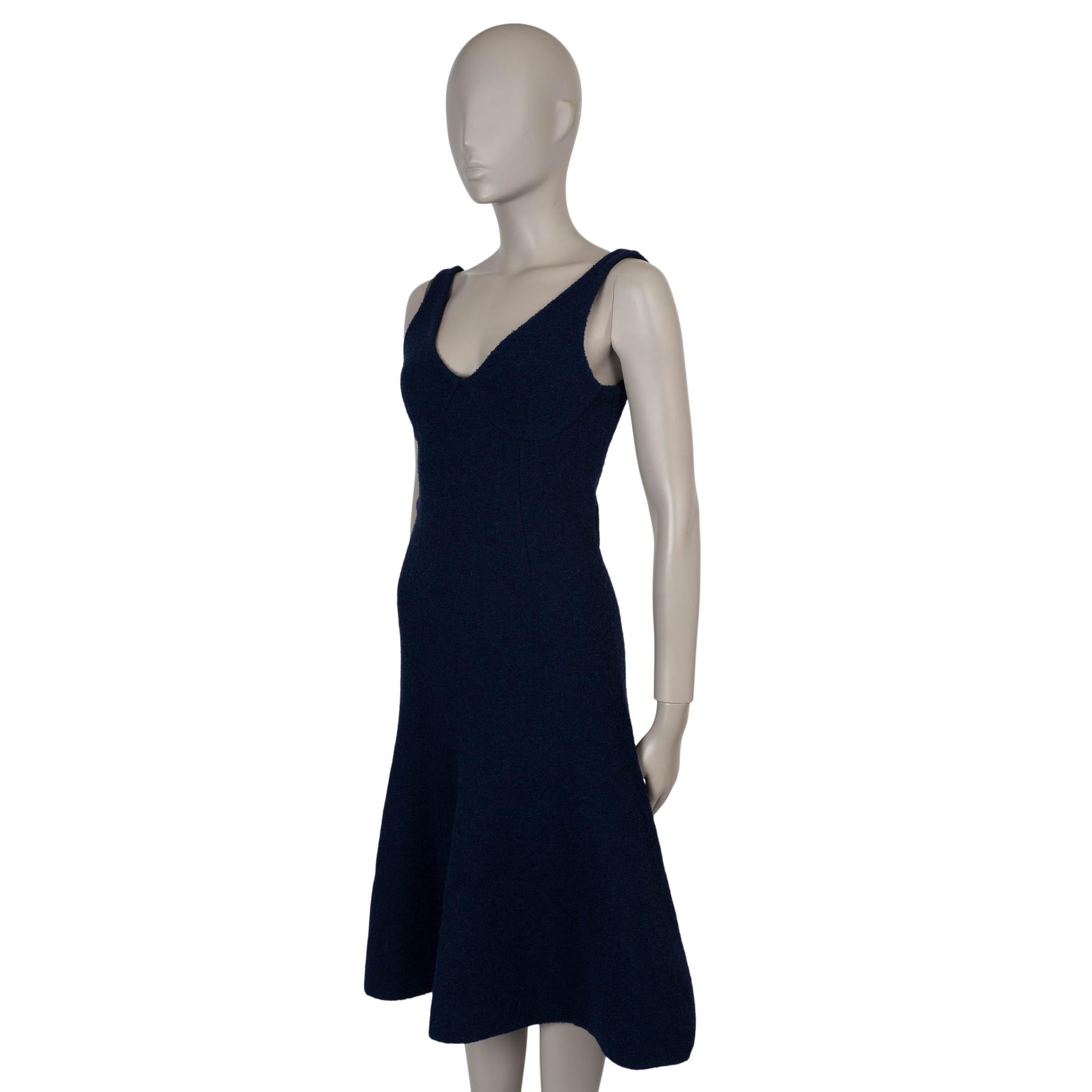 This 100% authentic Celine trumpet dress in midnight blue bouclé is crafted from a luxurious blend of viscose (38%), alpaca (35%), polyamide (18%), and polyester (9%). It features a fitted, sleeveless silhouette with a flared hem that adds graceful
