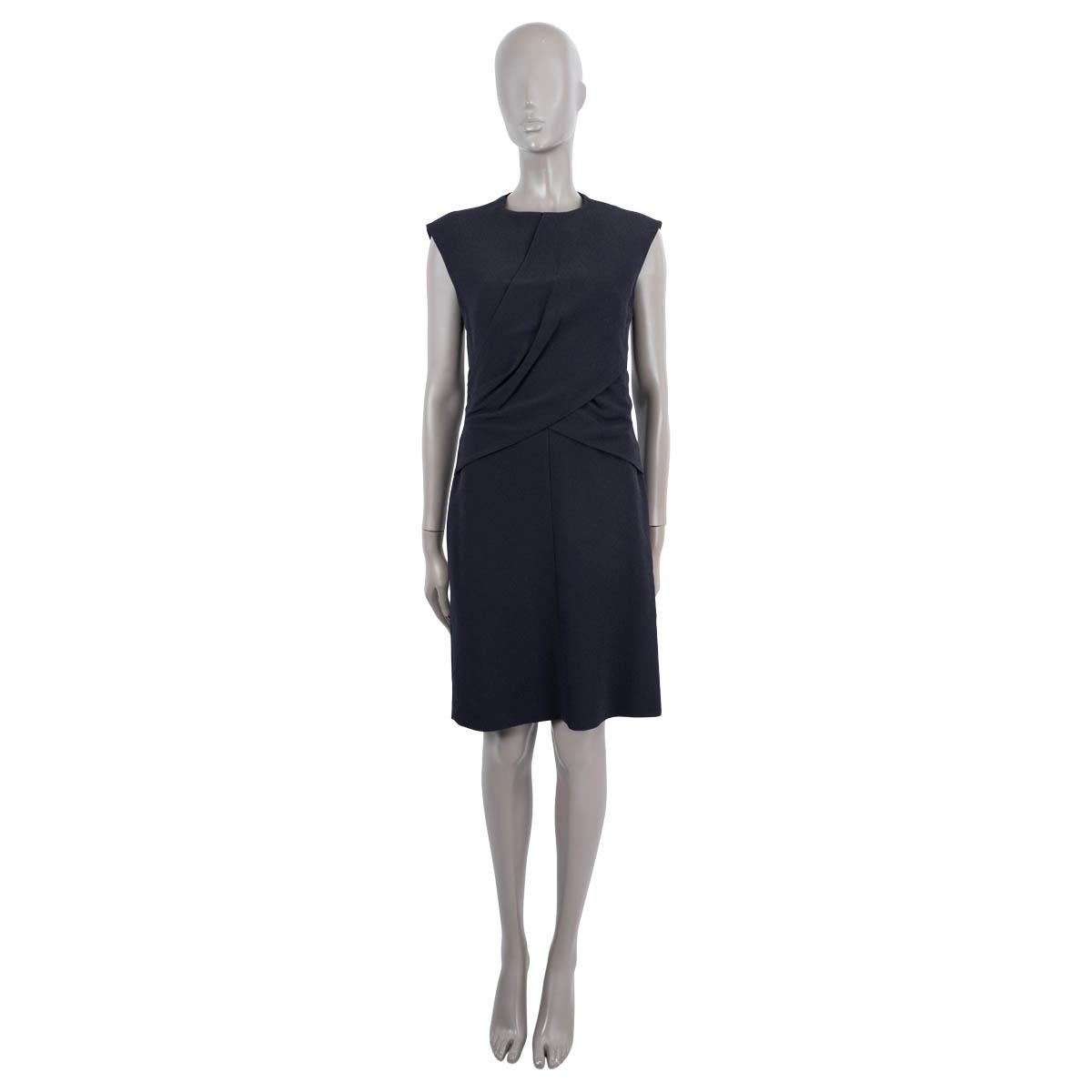 100% authentic Céline sleeveless shift dress in midnight blue viscose (68%) and silk (32%) with round neck-line and draped detail at the front. Features two pocket on the front. Closes with a zipper and hook on the back. Lined in black silk (100%).