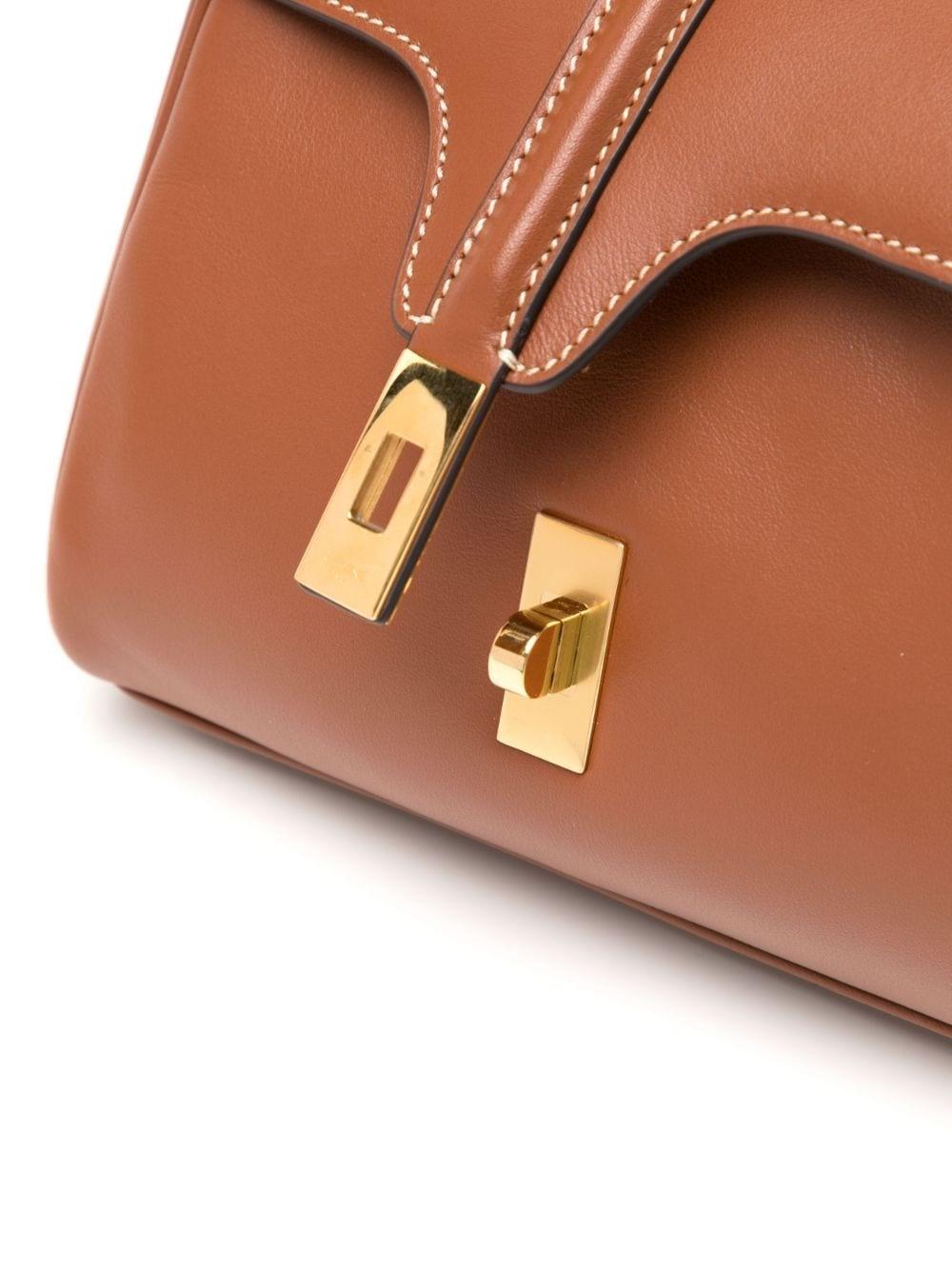 This Mini 16 bag from Celine is the epitome of quiet luxury. Crafted from CALFSKIN leather with lambskin lining and gold finishing, it is designed with versatility in mind. Features include a turn-lock closure, two main compartments, one inner flat