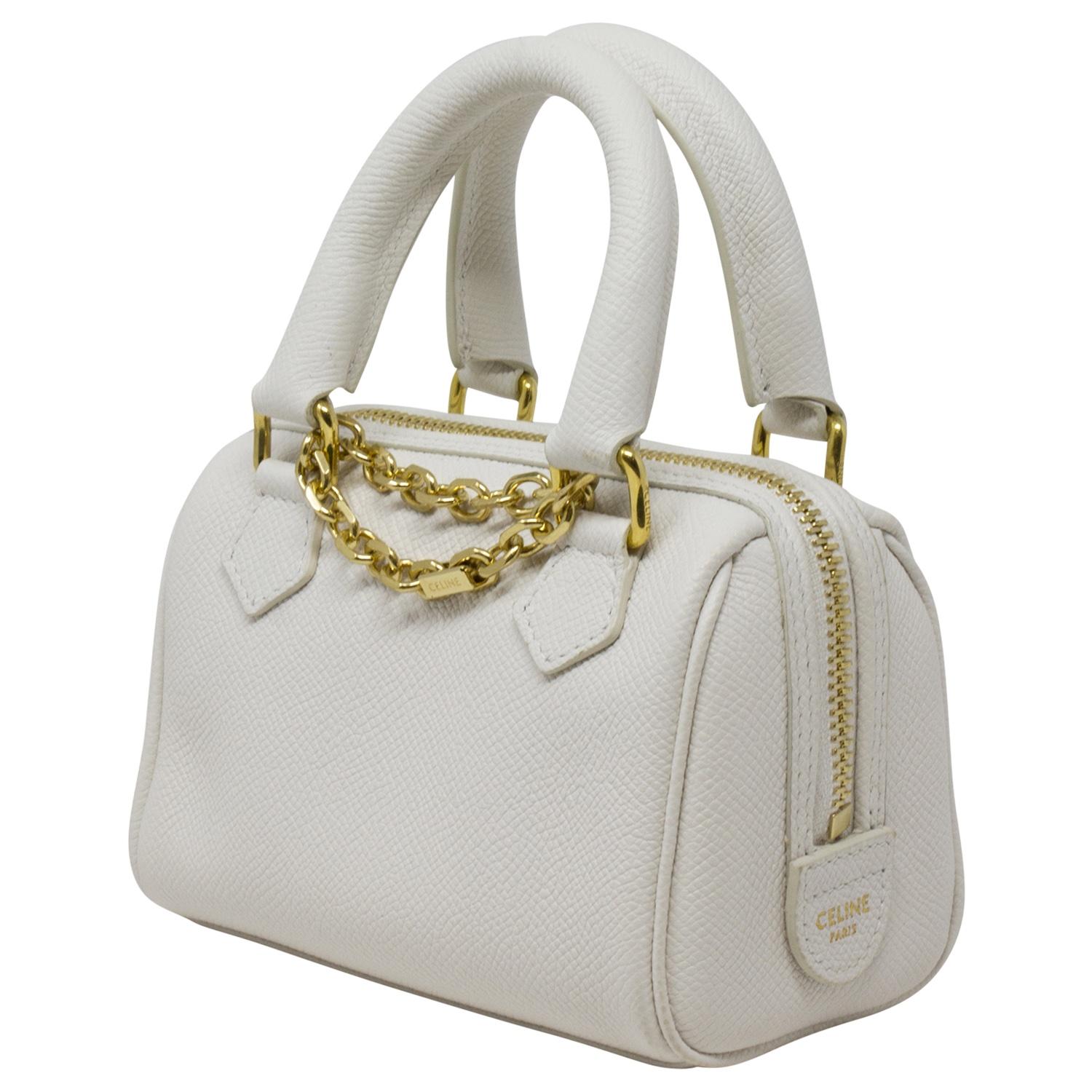 Too cute for us to handle! This Celine beauty is crafted in white grained leather, gold-tone hardware, an optional strap, chain-link charm and dual top handles. This limited edition mini is as timeless and adorable as it gets! The zipped closure