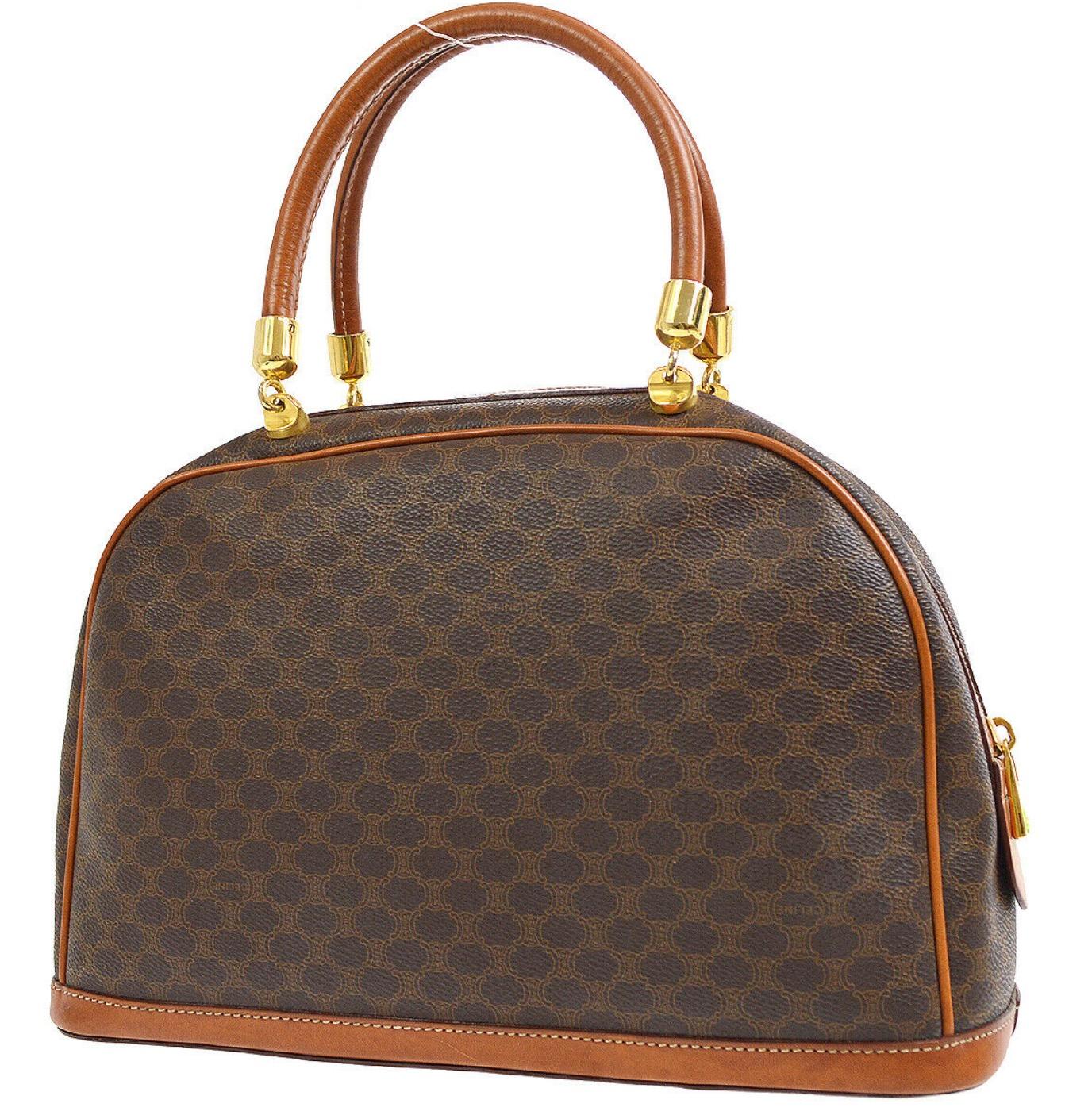 Monogram canvas
Leather trim
Leather lining
Gold tone hardware
Handle drop 6