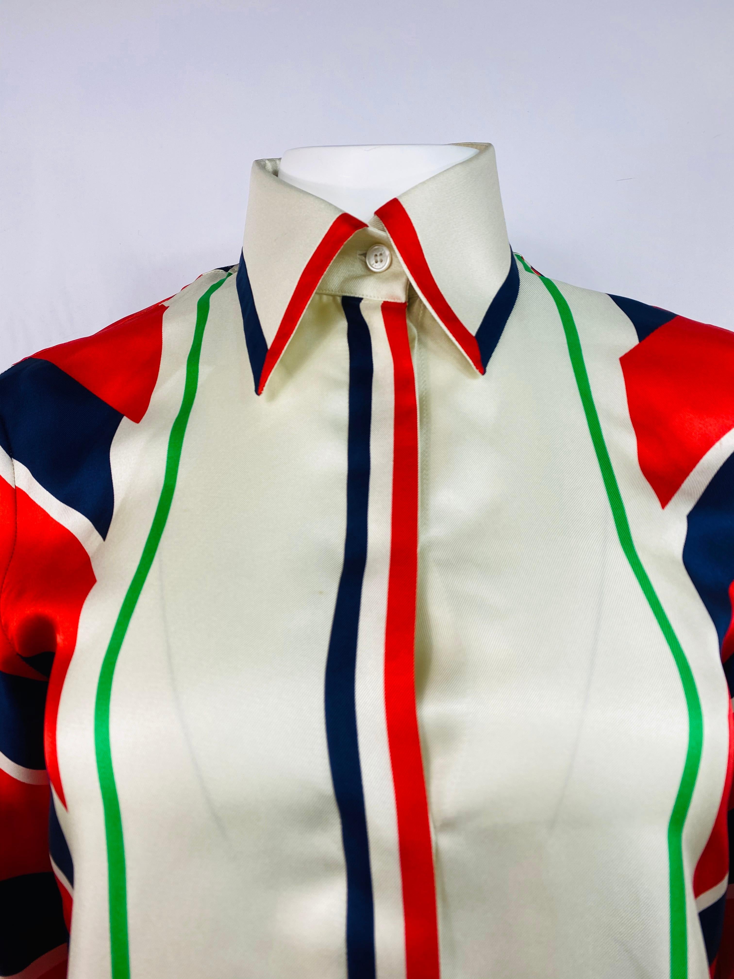 Product details:

Featuring cream, red, blue and green geometric/ striped print button down silk shirt/ blouse with long sleeves and color detail. 