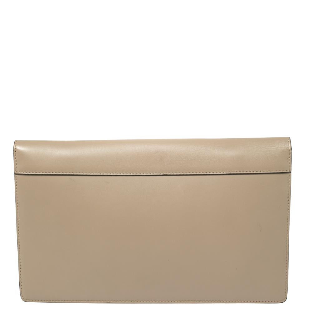 This diamond clutch from Celine is a statement piece you must own! It has been crafted from calf hair and leather and styled with a silver-tone tuck-in clasp on the front. It opens to a leather interior that houses two sip pockets and a zip pocket.