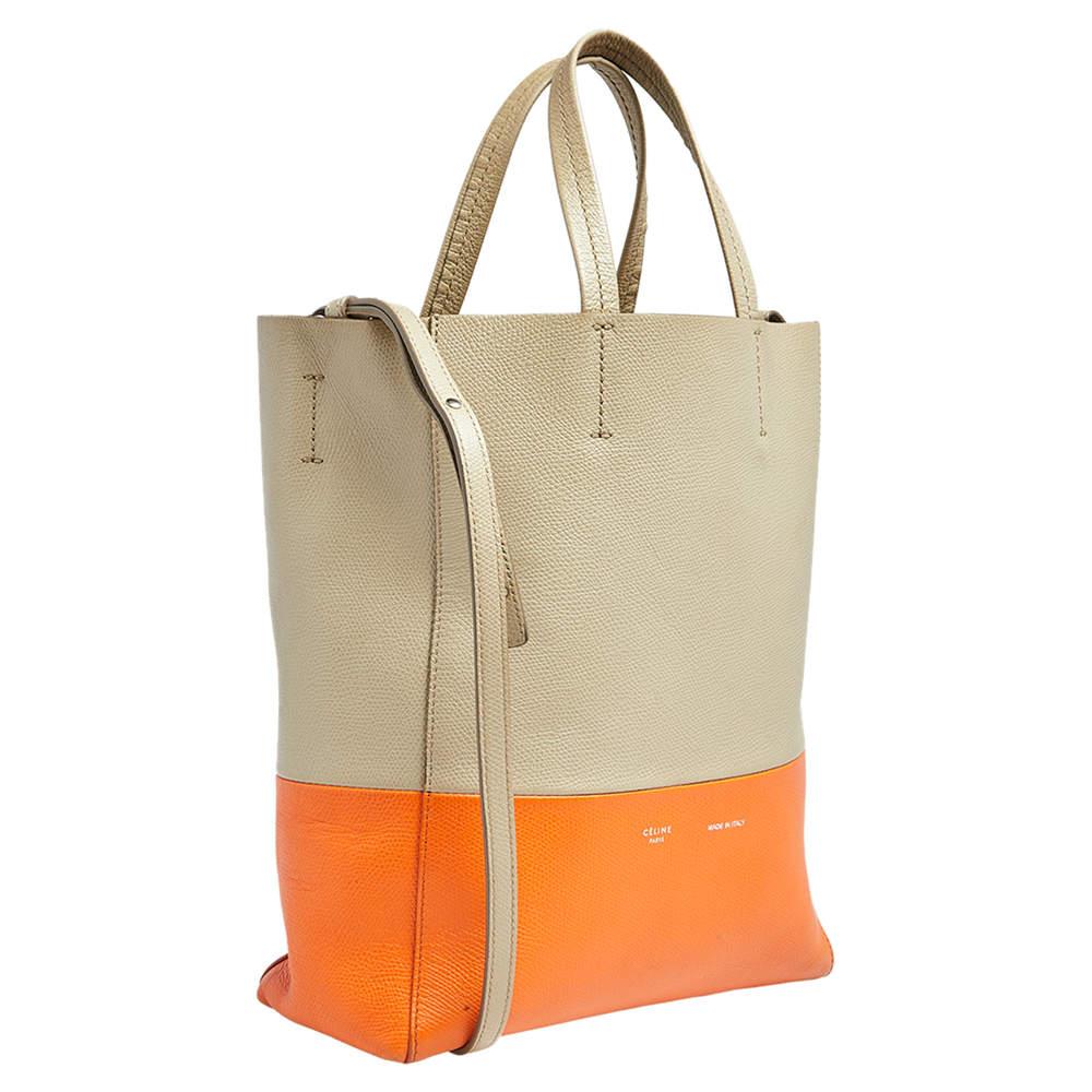 This Vertical Cabas tote brings a wonderful mix of fashion and function. This Celine tote has been crafted from grained leather in two shades. It is held by two top handles and equipped with a spacious interior for you to carry your essentials. Say