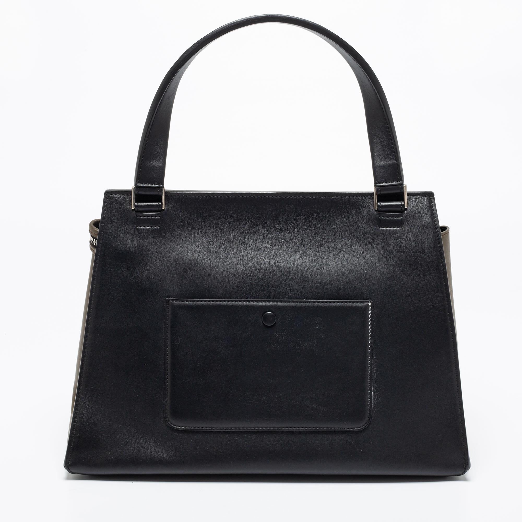 This Celine Edge bag is not only visually magnificent but also functional. It has been crafted from leather and is styled with a sleek structured silhouette. The multicolored bag has a top handle and opens into a spacious interior. It is complete