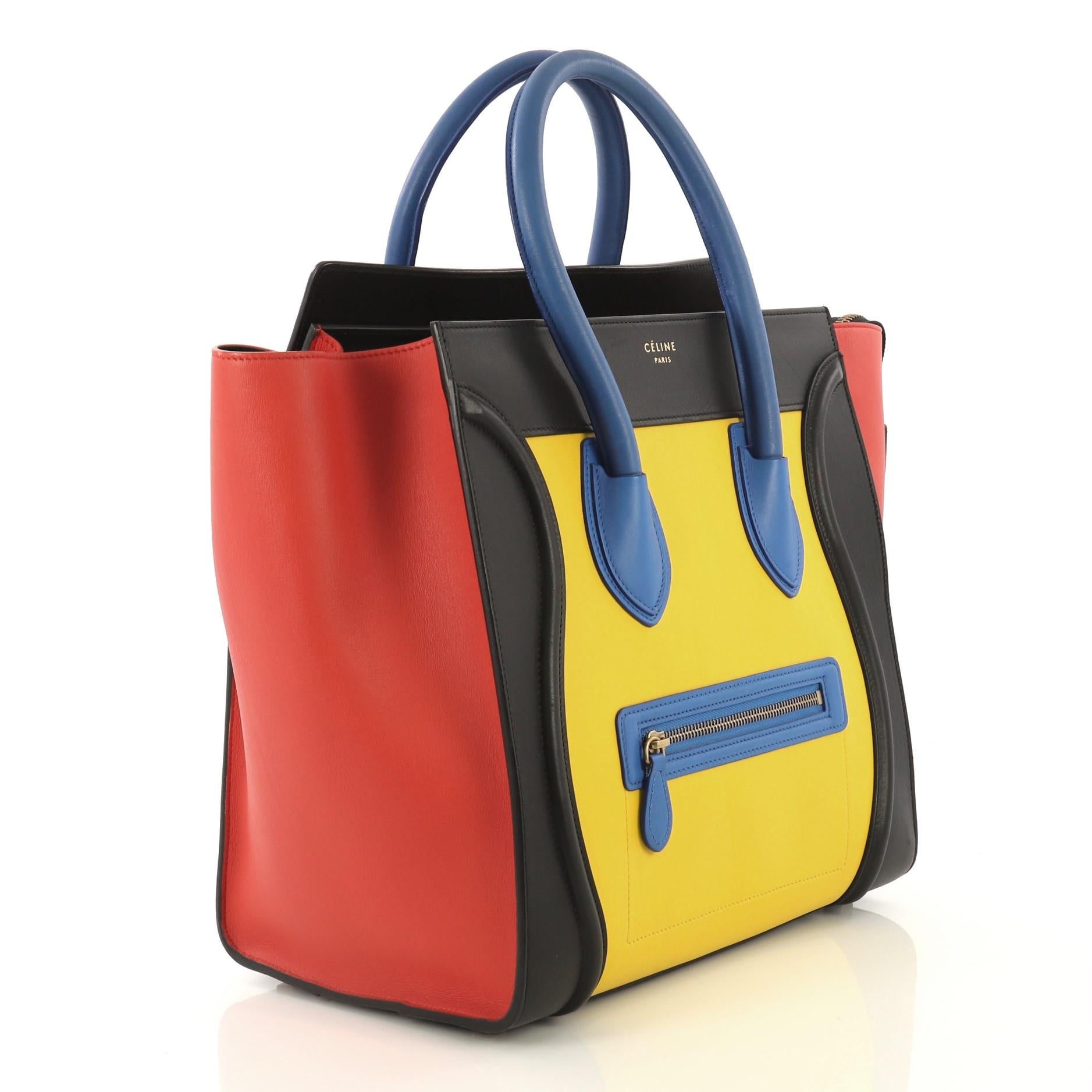 This Celine Multicolor Luggage Handbag Leather Mini, crafted in multicolor leather, features an exterior front zip pocket, dual rolled handles, protective base studs, and aged gold-tone hardware. Its top zip closure opens to a black leather interior