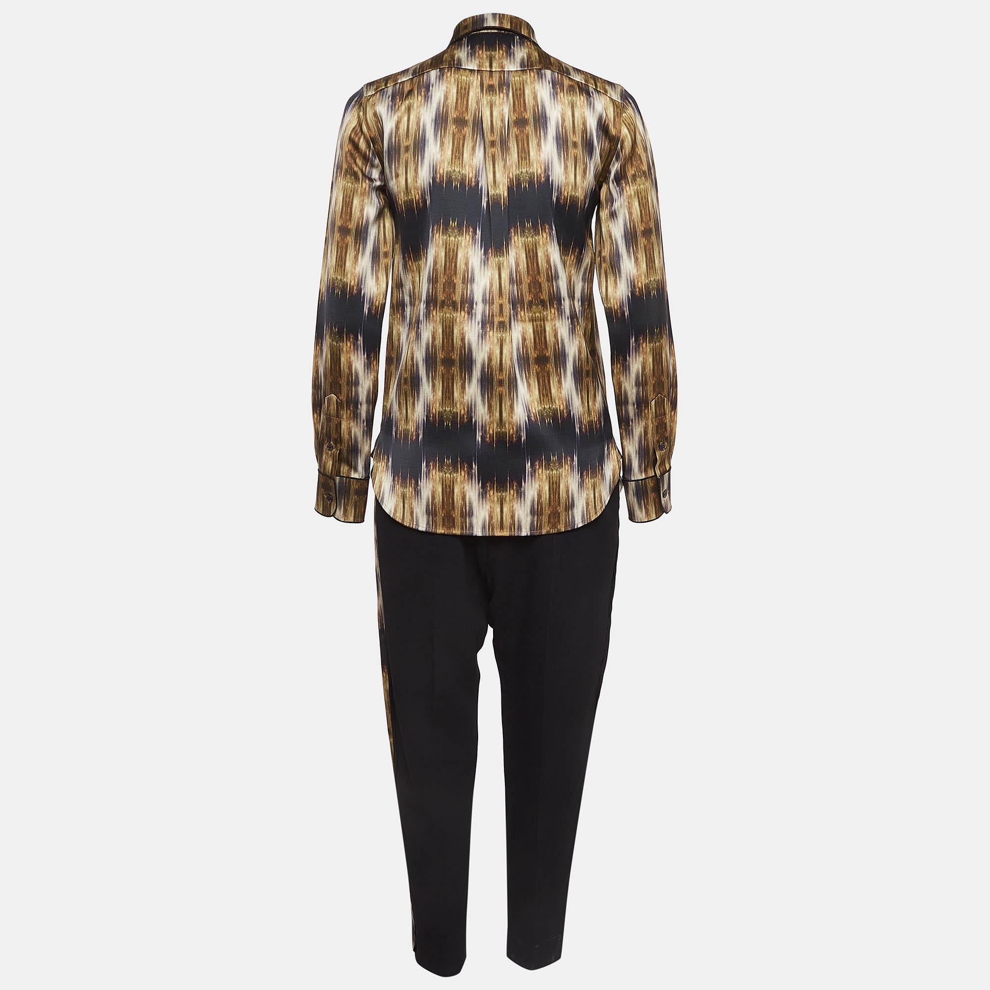 The Celine Pants Suit exudes sophistication and modern style. Crafted from high quality silk the multicolor print adds an eye catching effect. The blazer features a tailored fit while the pants showcase a classic silhouette. This ensemble