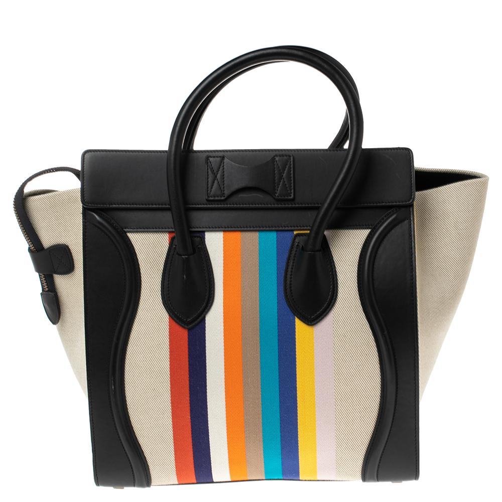 The mini Luggage tote from Celine is one of the most popular handbags in the world. This tote is crafted from stripe canvas and leather and designed in multicolors. It comes with rolled top handles and a front zip pocket. The bag is equipped with a