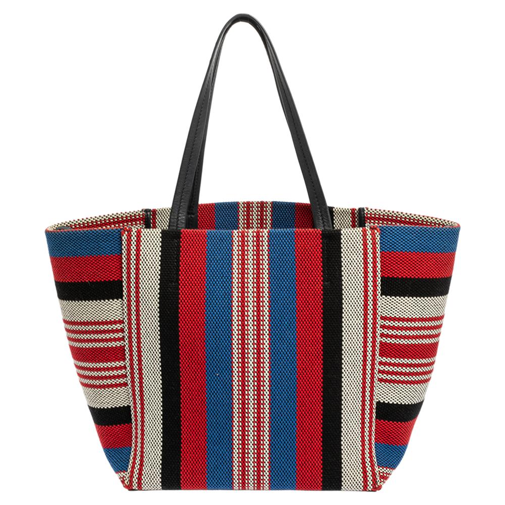 You can surely count on this stylish Phantom Cabas tote by Celine. Crafted from striped woven canvas, it features dual top flat straps and comes with a canvas-lined interior. This tote comes with a zipper pocket and carries brand labeling. It is