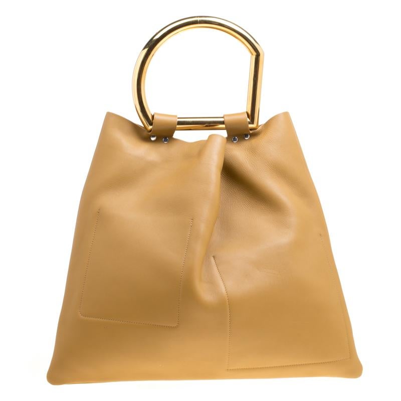 Handbags are more than just style statements. This Celine creation is crafted from different shades of leather and is designed for perfect summer days. The bag comes with slip pockets, one made from suede, snap buttons to secure the suede interior,