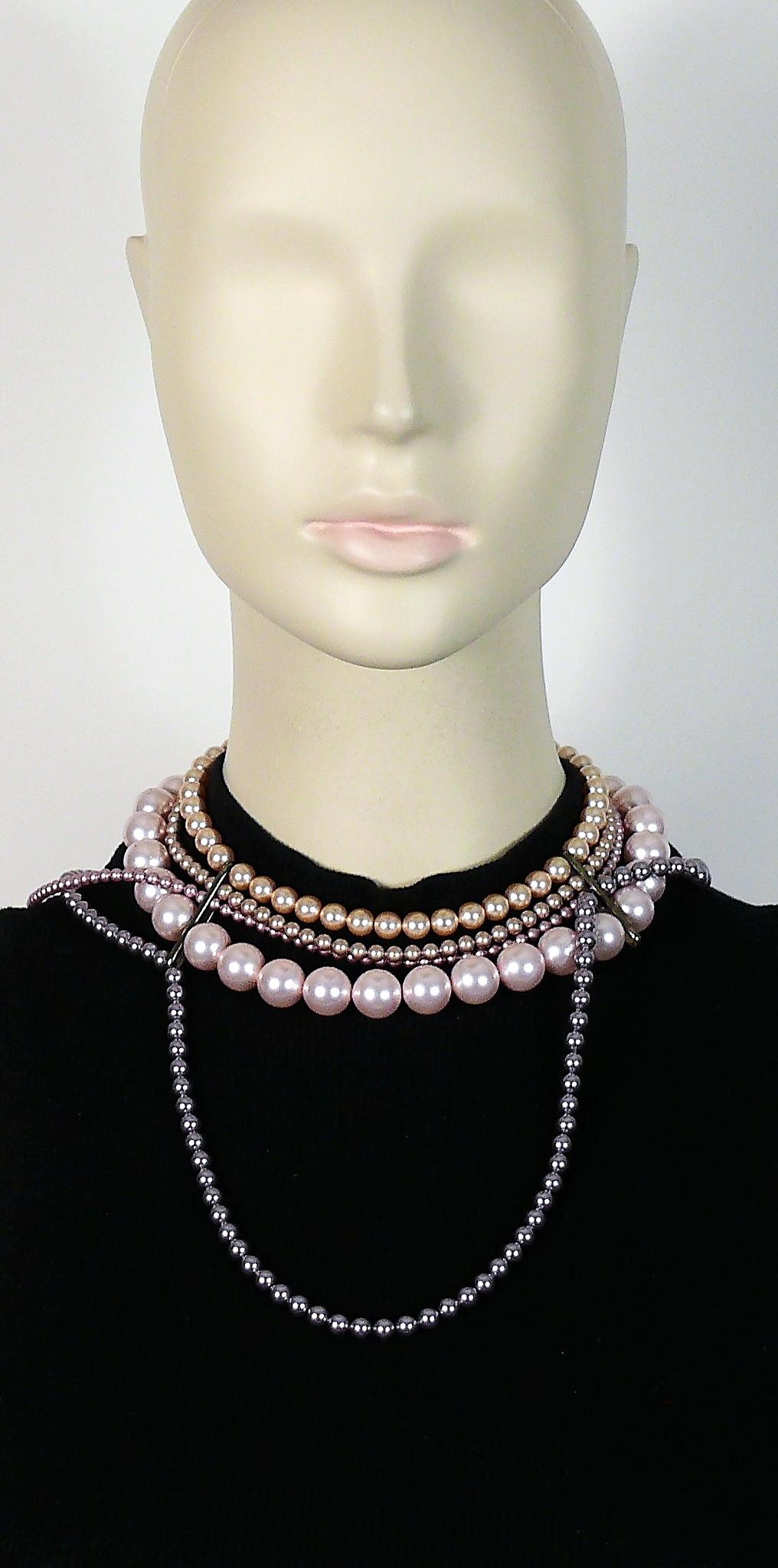 CELINE necklace featuring intertwined strands of multicolored faux glass pearls in shades of powder pink, purple, champagne...

Gun patina hardware.

CELINE logo charm.

Indicative measurements : length approx. 37 cm (14.57 inches).

JEWELRY