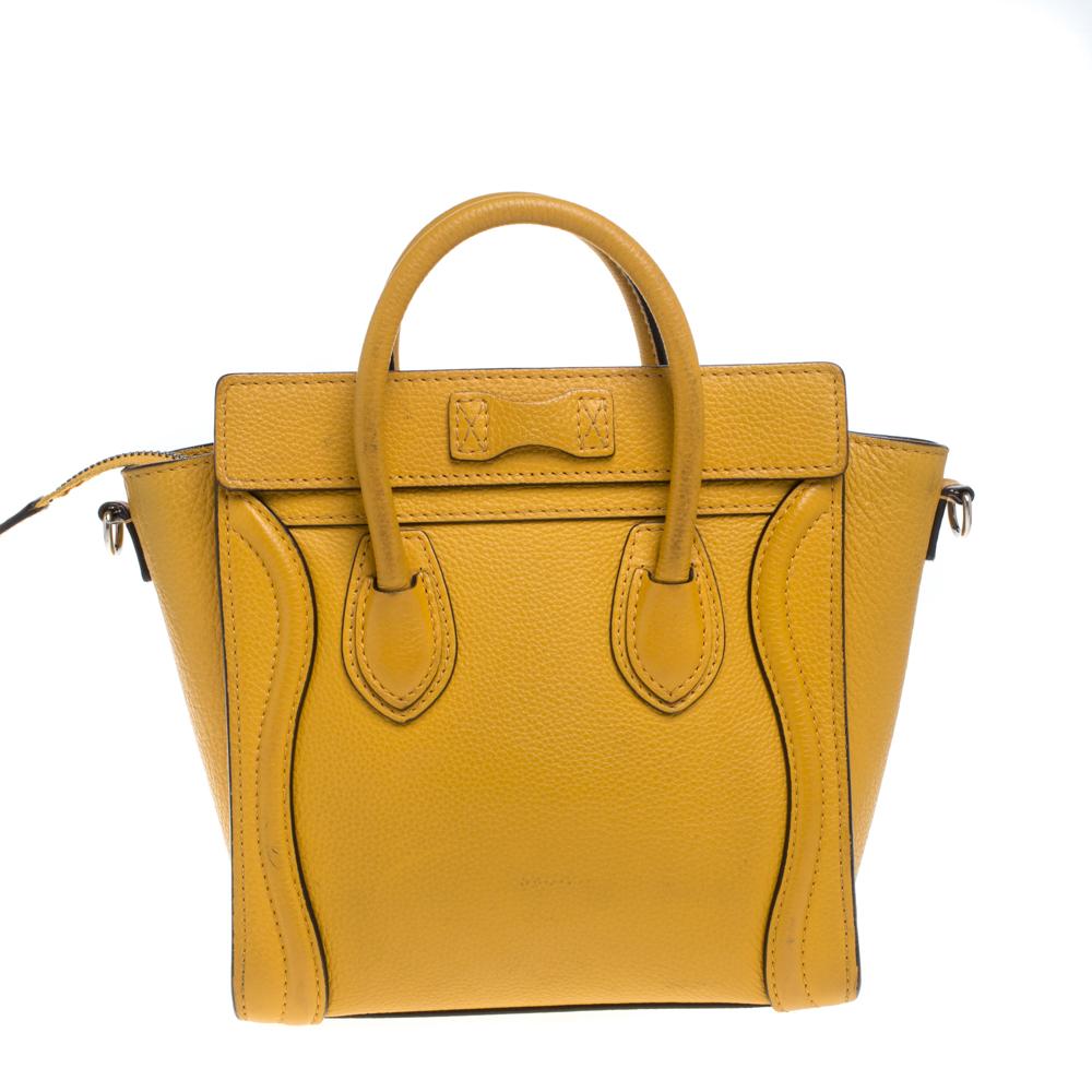 The Nano Luggage tote from Celine is one of the most popular handbags in the world. This tote is crafted from leather and designed in a mustard yellow hue. It comes with rolled top handles, a detachable shoulder strap, and a front zip pocket. The