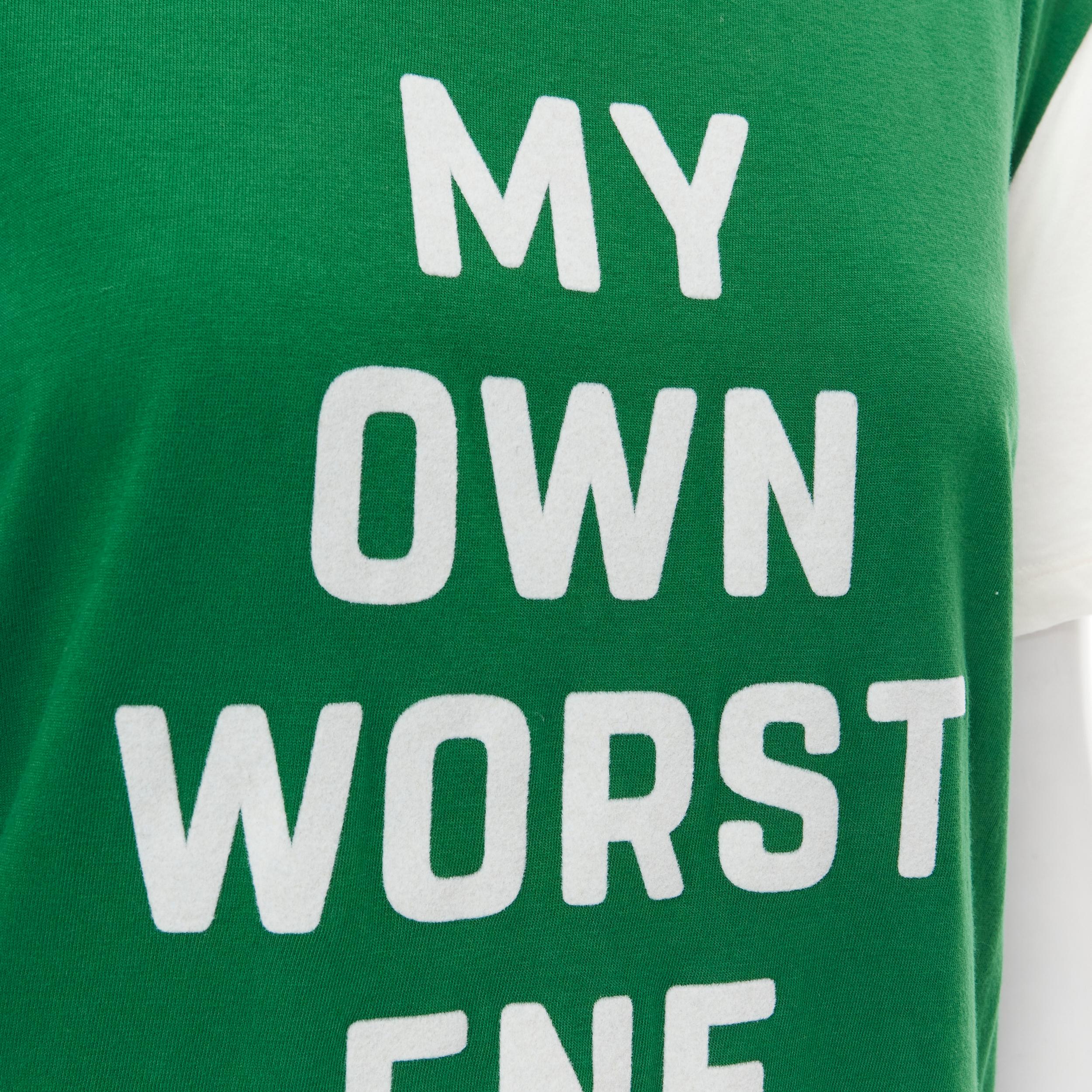 CELINE My Own Worst Enemy green white cotton tshirt L 
Reference: MELK/A00134 
Brand: Celine 
Designer: Hedi Slimane 
Material: Cotton 
Color: Green 
Pattern: Solid 
Made in: Italy 

CONDITION: 
Condition: Excellent, this item was pre-owned and is