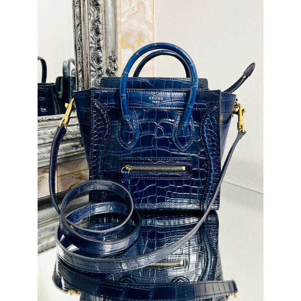 Celine Nano Luggage Bag In Crocodile Skin 

Dark blue shiny Crocodile skin with gold hardware. Top carry handles or wear cross body with removable shoulder strap.

Additional information:
Size – 25 W x 11 D x 19 H cm Nano Model
Composition –