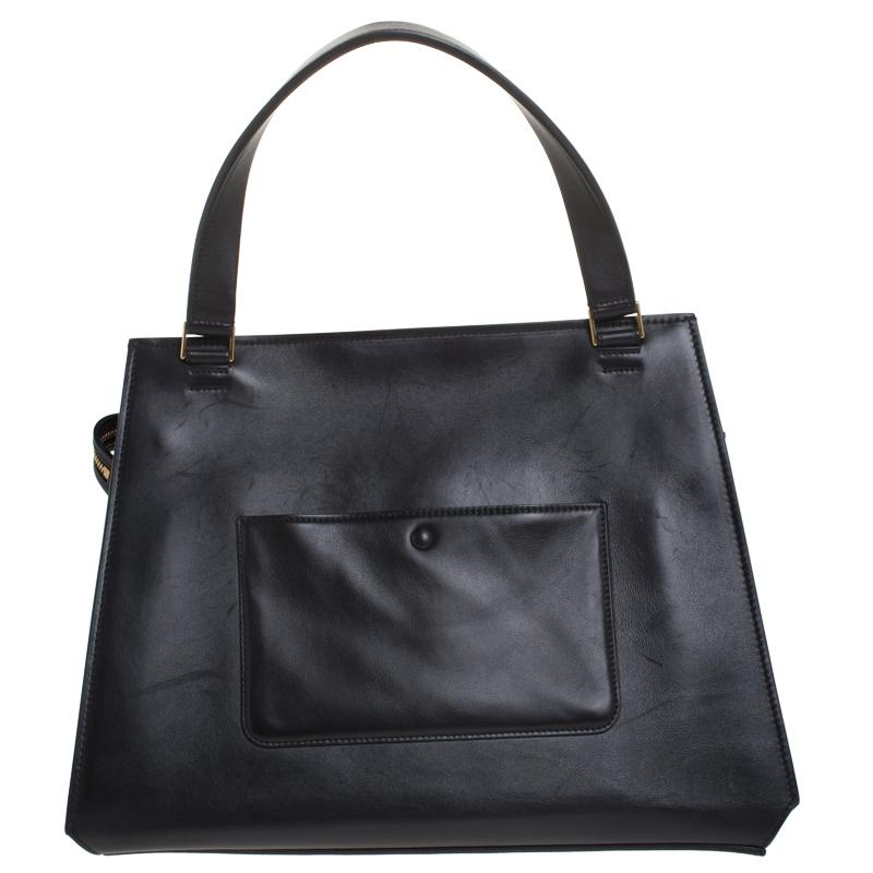 This Celine Edge bag is not only visually magnificent but also functional. It has been crafted from leather and styled with a silhouette that is classy and posh. The black/navy blue bag has a top handle and a top zipper that reveals a spacious