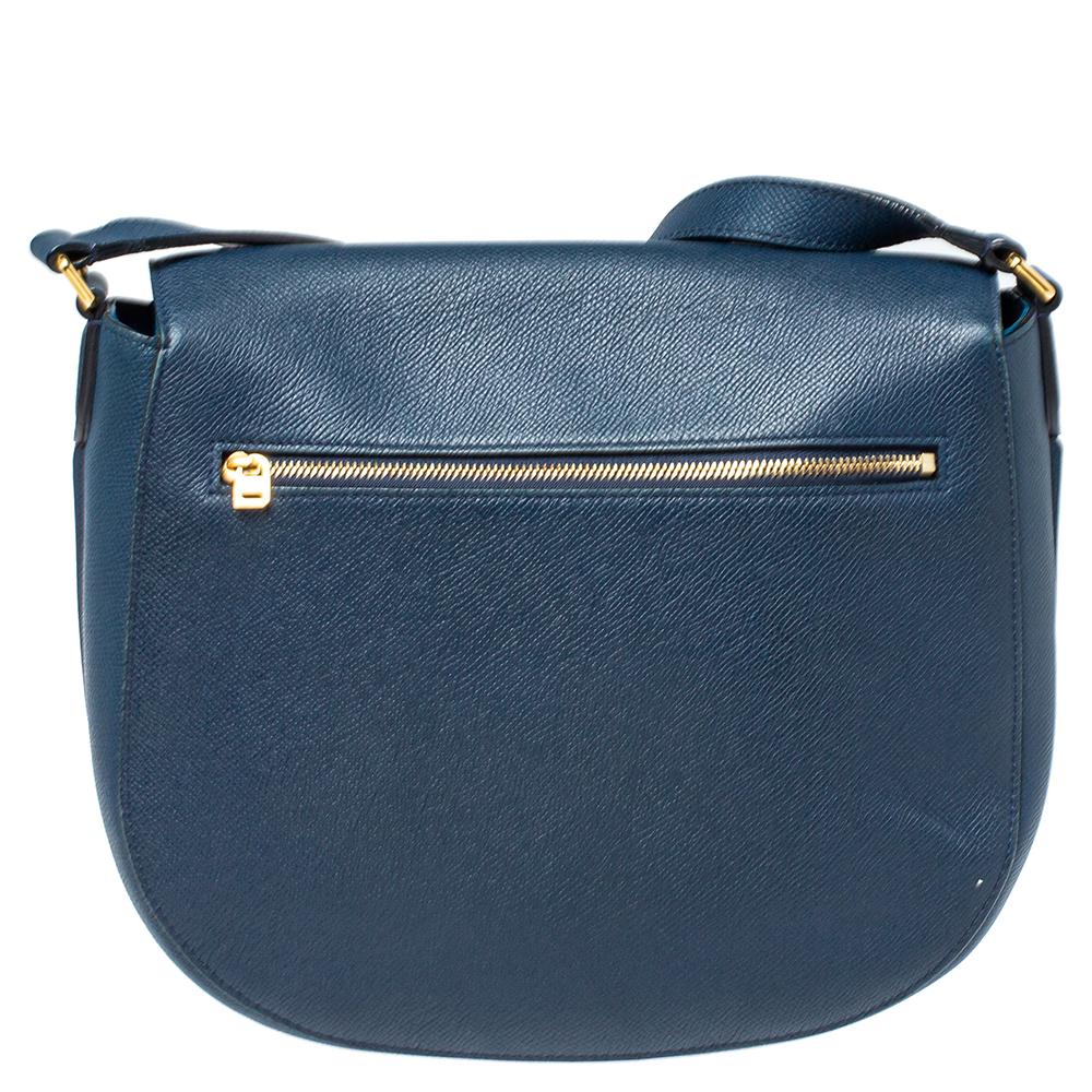 How cute and adorable is this bag from Celine! The navy blue bag is crafted from leather and features a compact silhouette. It flaunts a front tuck-in flap closure that opens to a leather-lined spacious interior capable enough of carrying your daily