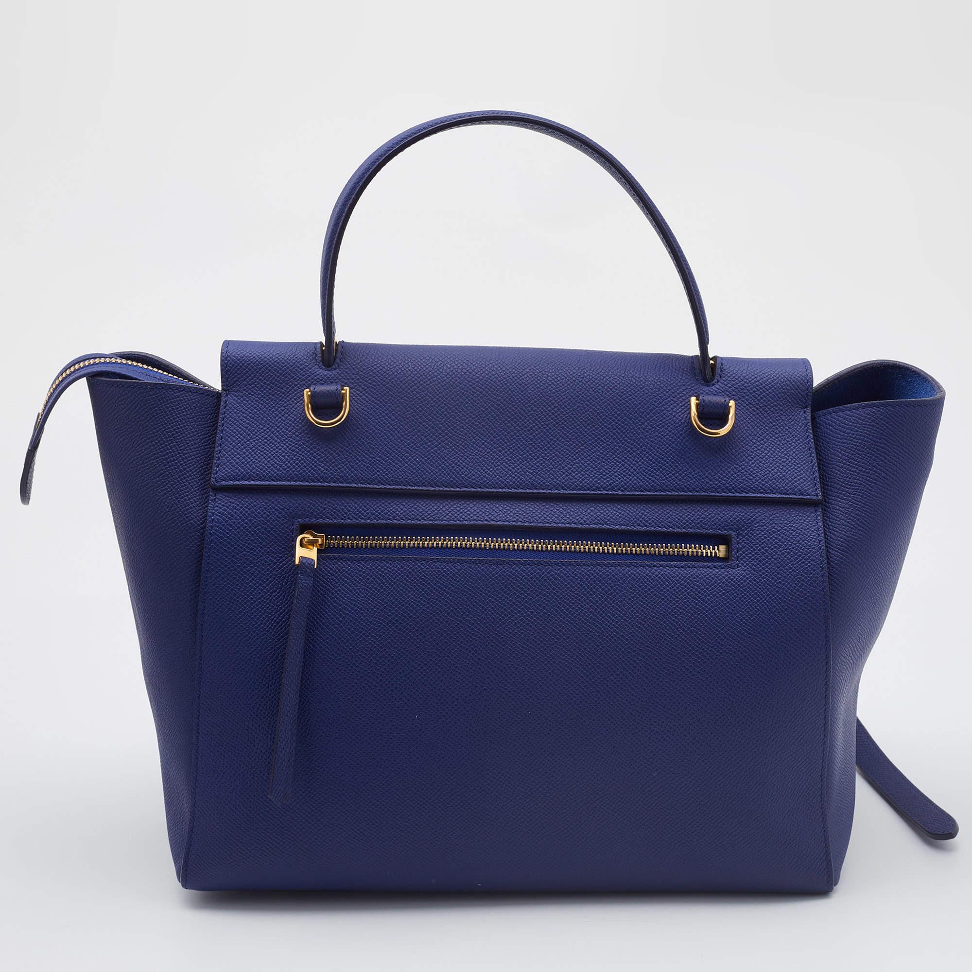 This bag from the house of Celine is an accessory you would go to season after season. It has been crafted from navy blue leather into a flap style. It comes with a top handle, an optional strap, and a well-lined interior.

Includes: Original