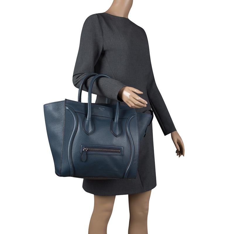 The Mini Luggage tote from Celine is one of the most popular handbags in the world. This tote is crafted from leather and it features a classy navy blue exterior with the signature flappy wings. It comes with rolled top handles, front zip pocket,