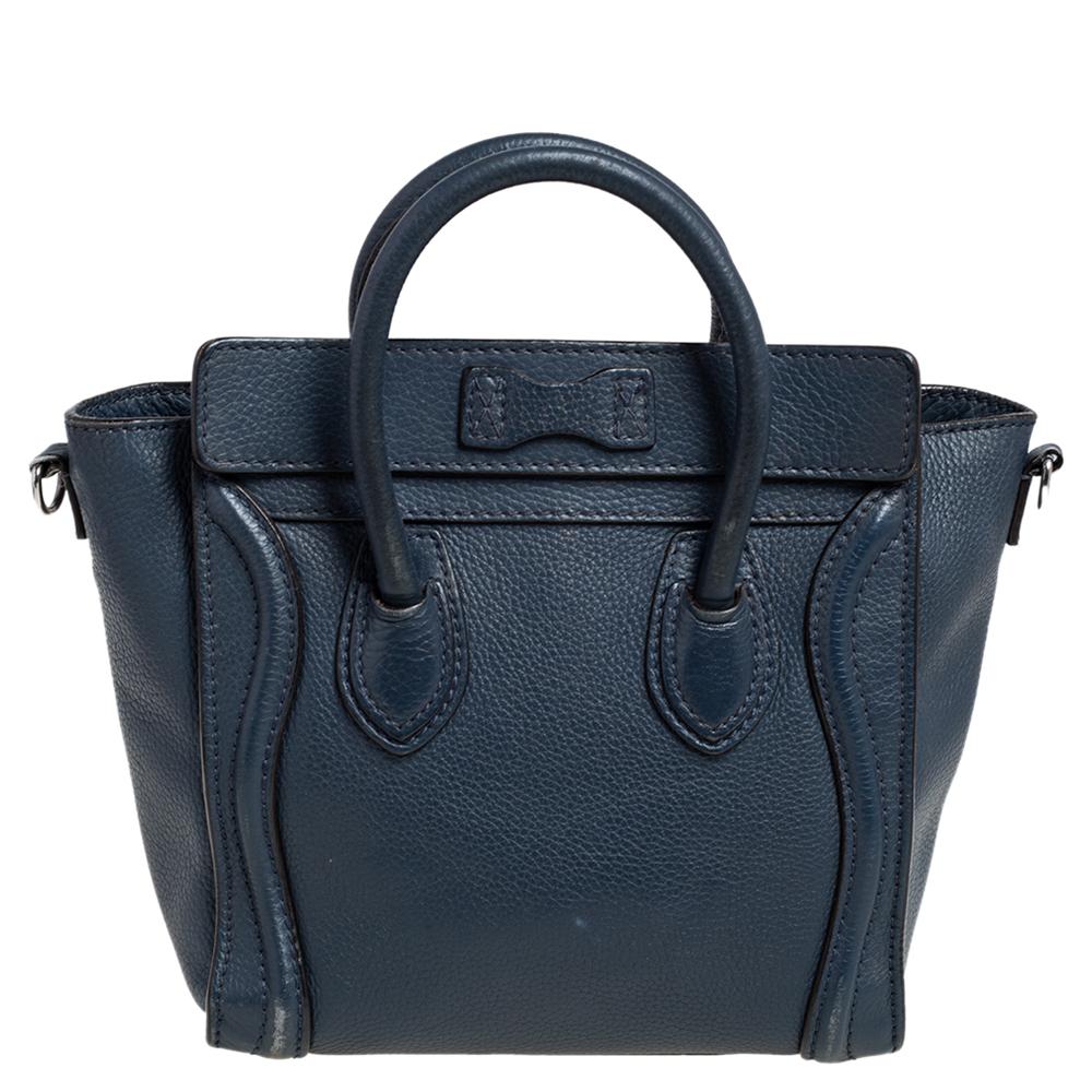 The Luggage tote from Céline is one of the most popular handbags in the world. This tote is crafted from leather and designed in a navy blue shade. It comes with rolled top handles, a detachable shoulder strap, and a front zip pocket. The bag is