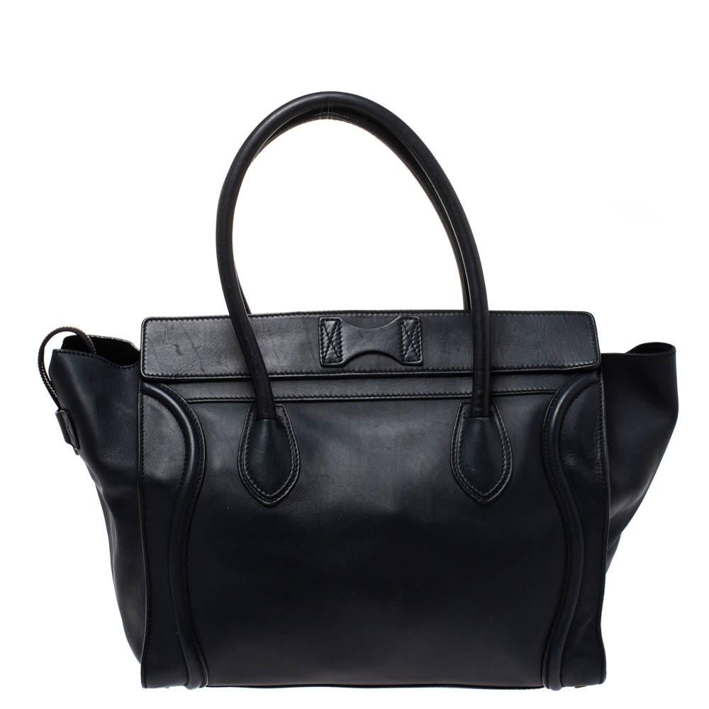 The Luggage tote from Celine is one of the most popular handbags in the world. This tote is crafted from leather and designed in a navy blue shade. It comes with rolled top handles, protective metal feet and a front zip pocket. The bag is equipped