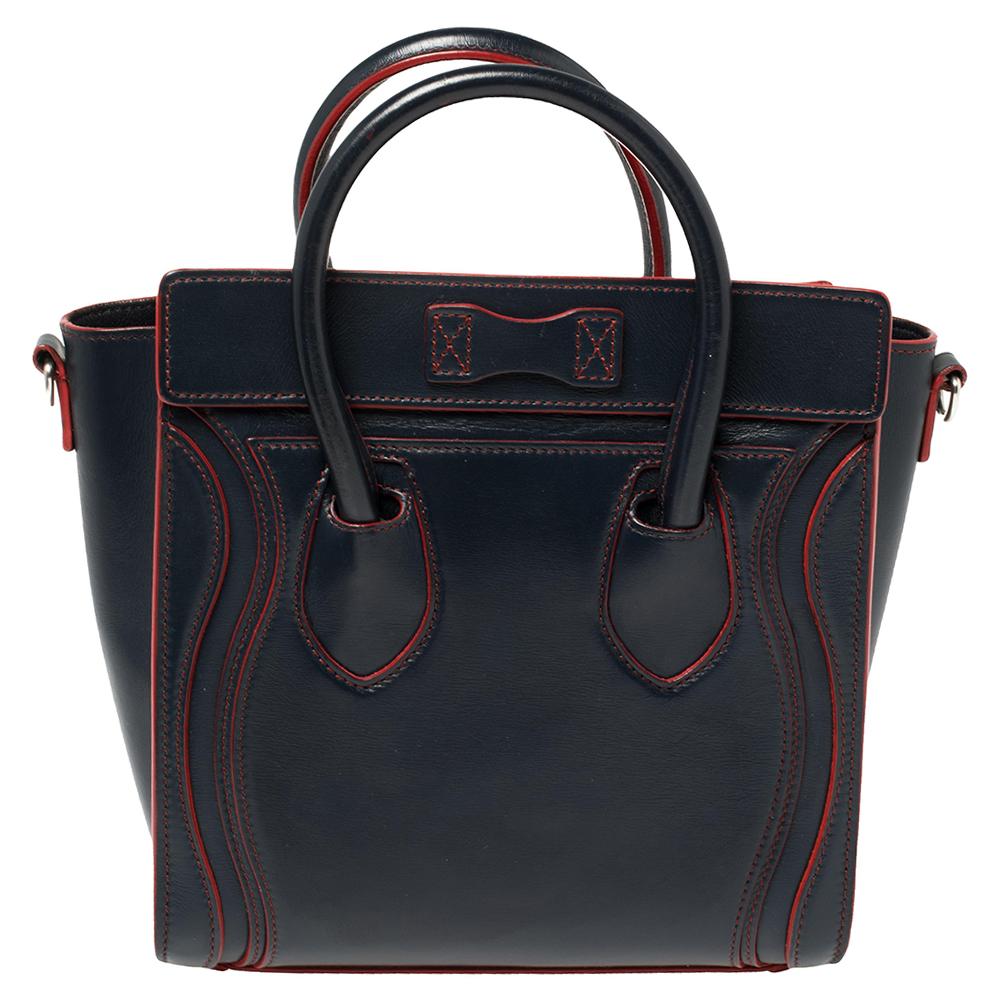 The Nano Luggage tote from Celine is one of the most popular handbags in the world. This tote is crafted from leather and designed in navy blue and red hues. It comes with rolled top handles, a detachable shoulder strap, and a front zip pocket. The