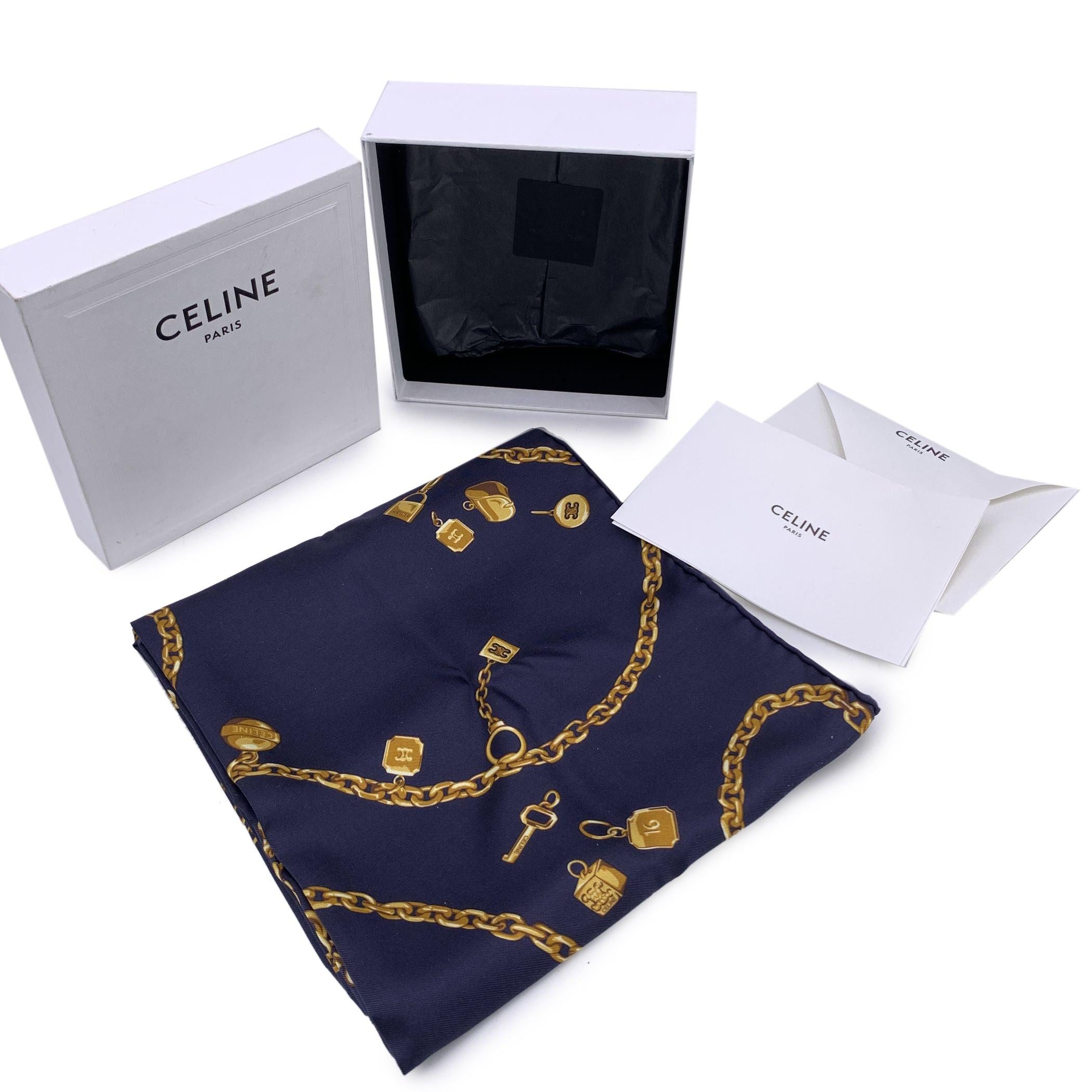 Step into the world of timeless elegance with this Céline Square Silk Twill Scarf, a luxurious piece that effortlessly blends sophistication with a touch of charm. Crafted from 100% silk and featuring a striking navy blue base adorned with a golden
