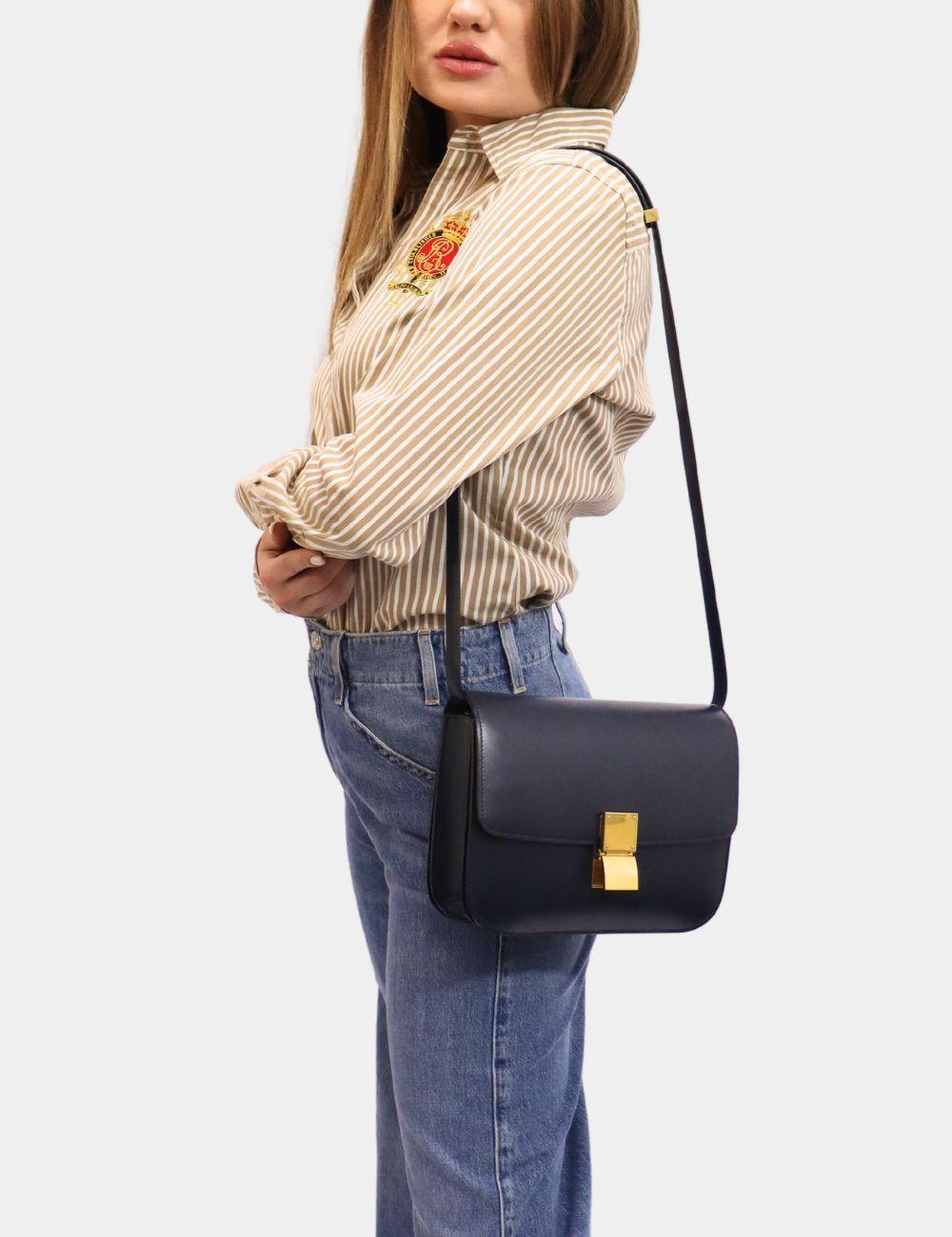 Celine Navy Leather Medium Classic Box Shoulder Bag, Features a leather adjustable strap, gold plaque, two compartments and one interior pocket.

Material: Leather
Hardware: Gold
Height: 18cm
Width: 23cm
Depth: 8cm
Strap Drop: 44cm
Overall