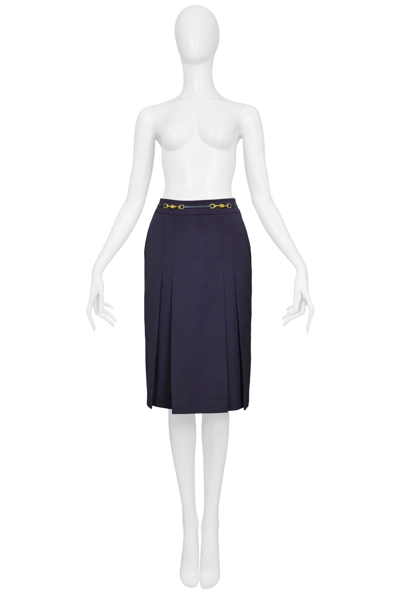 Resurrection Vintage is excited to offer a vintage navy purple Celine skirt featuring box pleats, a hidden zipper on the side back, and a thin black belt attached to the front waistband with gold links.

Celine, Paris
Size 36
100% Wool 
Excellent