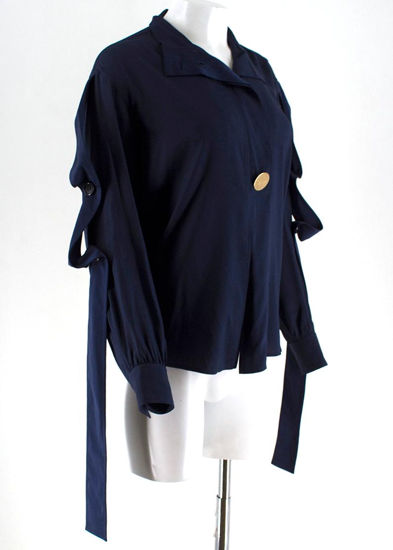 Celine Navy Silk Button Embellished Shirt

- Navy silk shirt 
- Button down to the middle front 
- Golden button embellishment to the font
- Black buttons embellishment to the collar snd sleeves

Please note, these items are pre-owned and may show