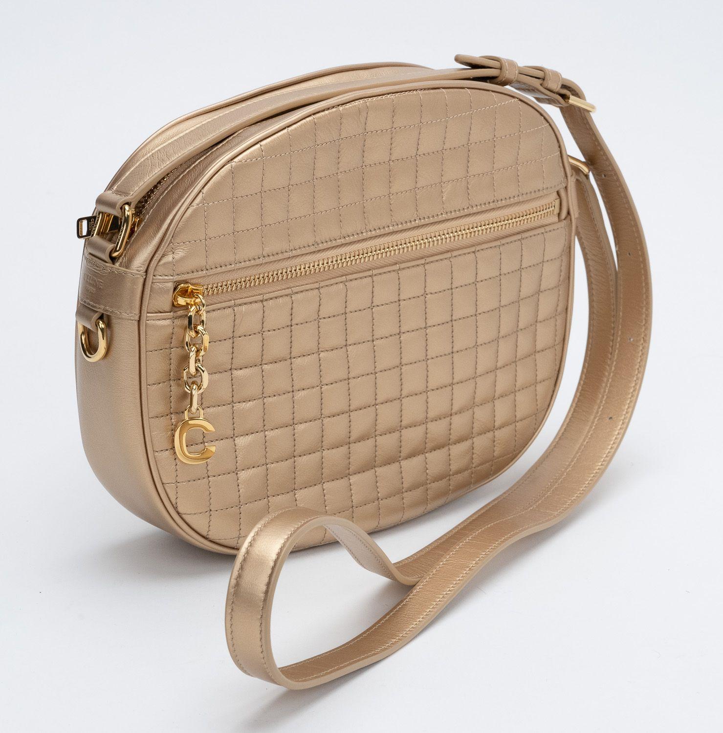 Celine Brand New Laminated Gold Quilted Calfskin Cross body Bag with gold metal C charm. Adjustable shoulder shoulder strap and a front zipper pocket. Beige fabric interior lining. Comes with booklet and original dust cover.