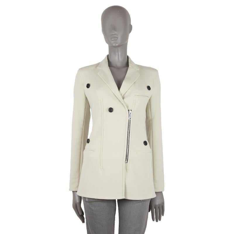 authentic Celine SS'16 double-breasted blazer in vanilla wool (95%), nylon (3%), and elastane (2%). With notch collar, three welt pockets on the front, and decorative black buttons on the front. CLoses with metal zipper on the front Partially lined