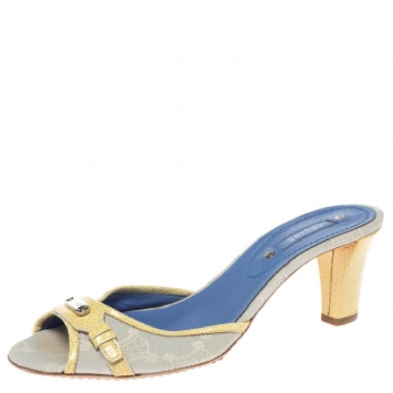 Wear these silver slides on days when you cannot choose between fashion and comfort for they bring both. They are from Celine, designed with signature Macadam coated canvas and patent leather trims, featuring signature-detailed metal accent on the
