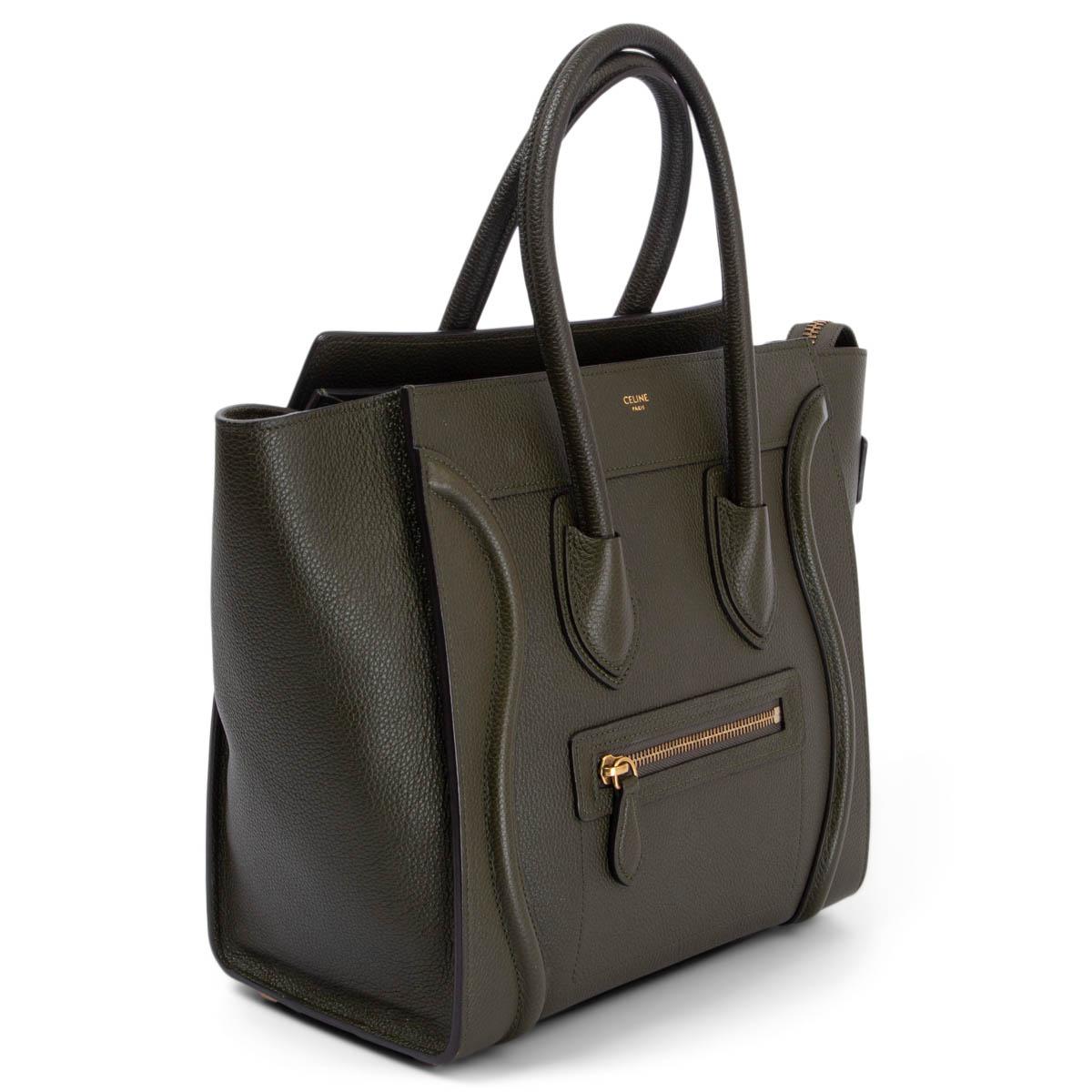 100% authentic Céline Micro Luggage in olive green grained calfskin. Opens with a zipper on top and is lined in olive green suede leather with two open pockets against the front and one zipper pocket against the back. Has been carried and is in